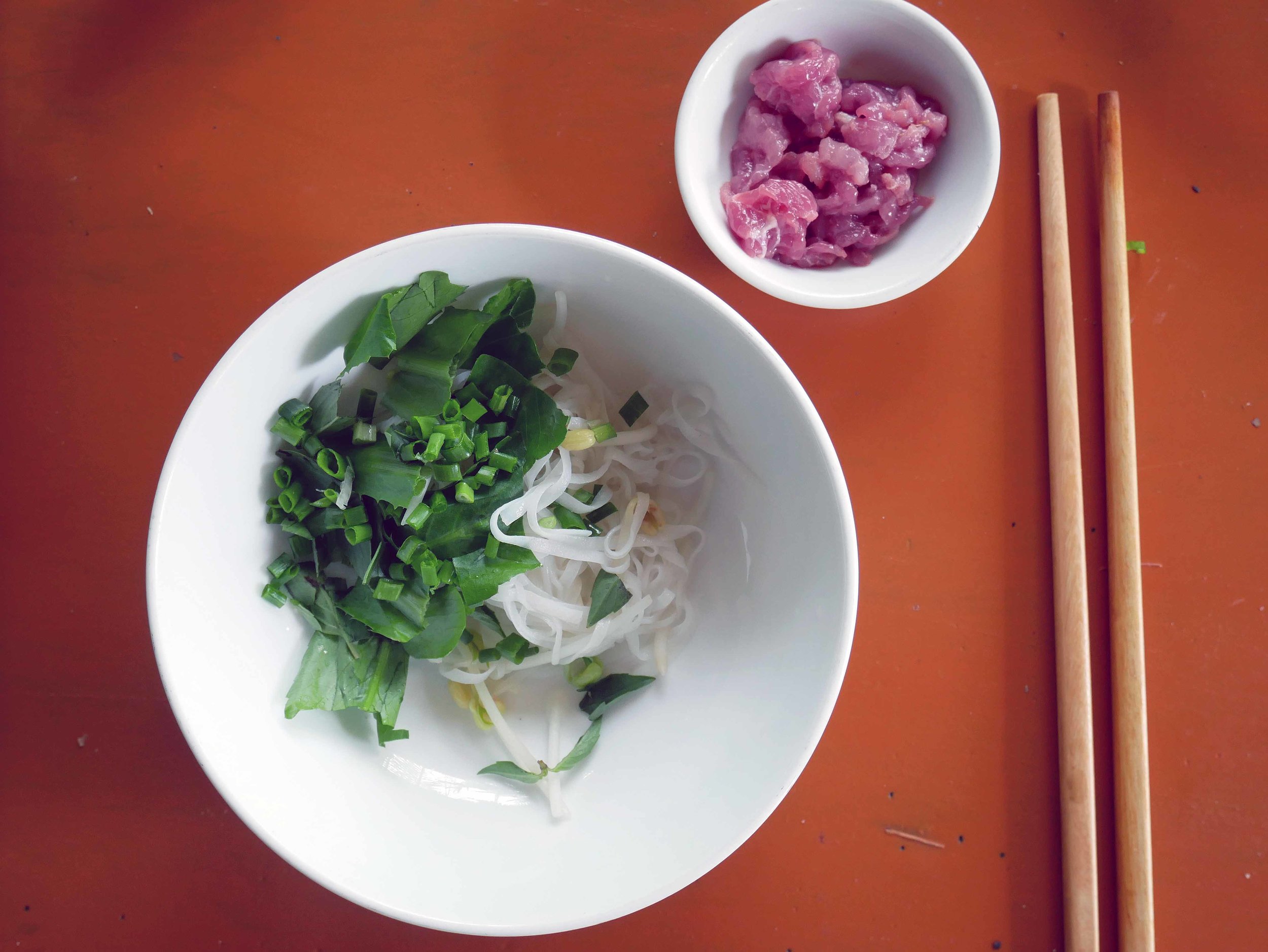  After briefly cooking the rice noodles for our Pho, we smothered them in bean sprouts, fresh mint and scallions, along with pickled shallot, in anticipation for the steaming beef broth.&nbsp; 