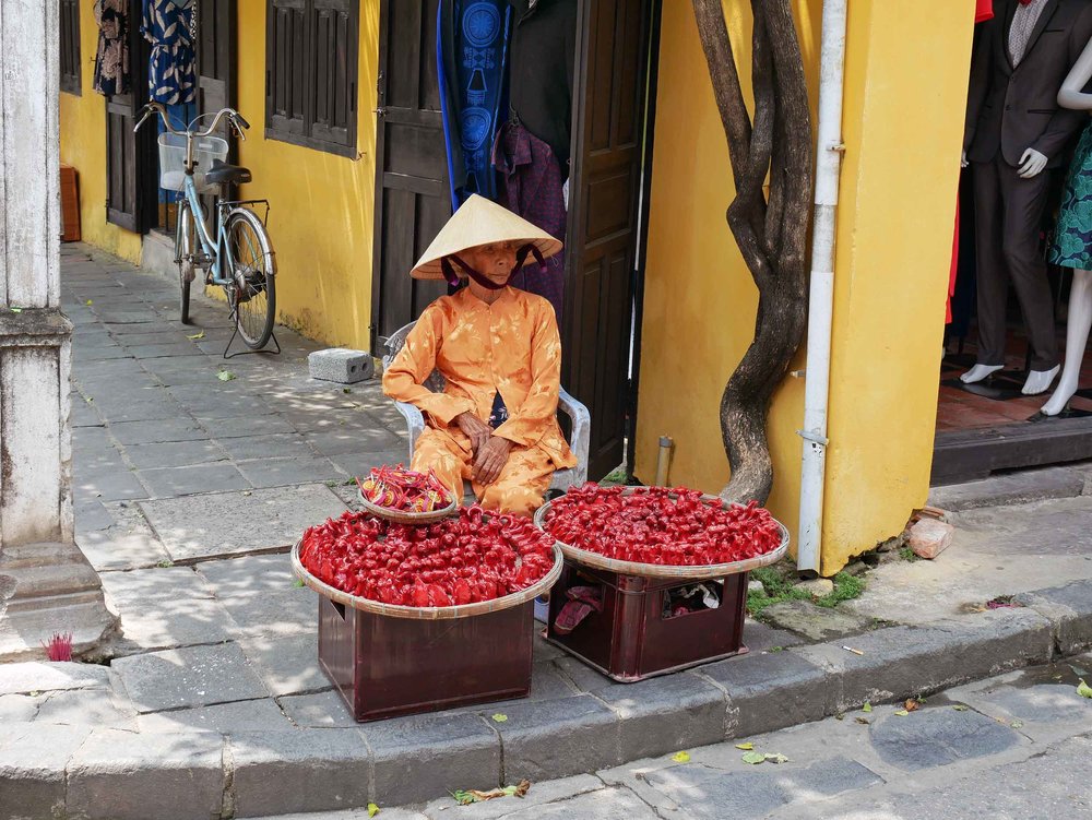  Vietnamese ladies line the small lanes through the Ancient Town selling souvenirs and gifts. 