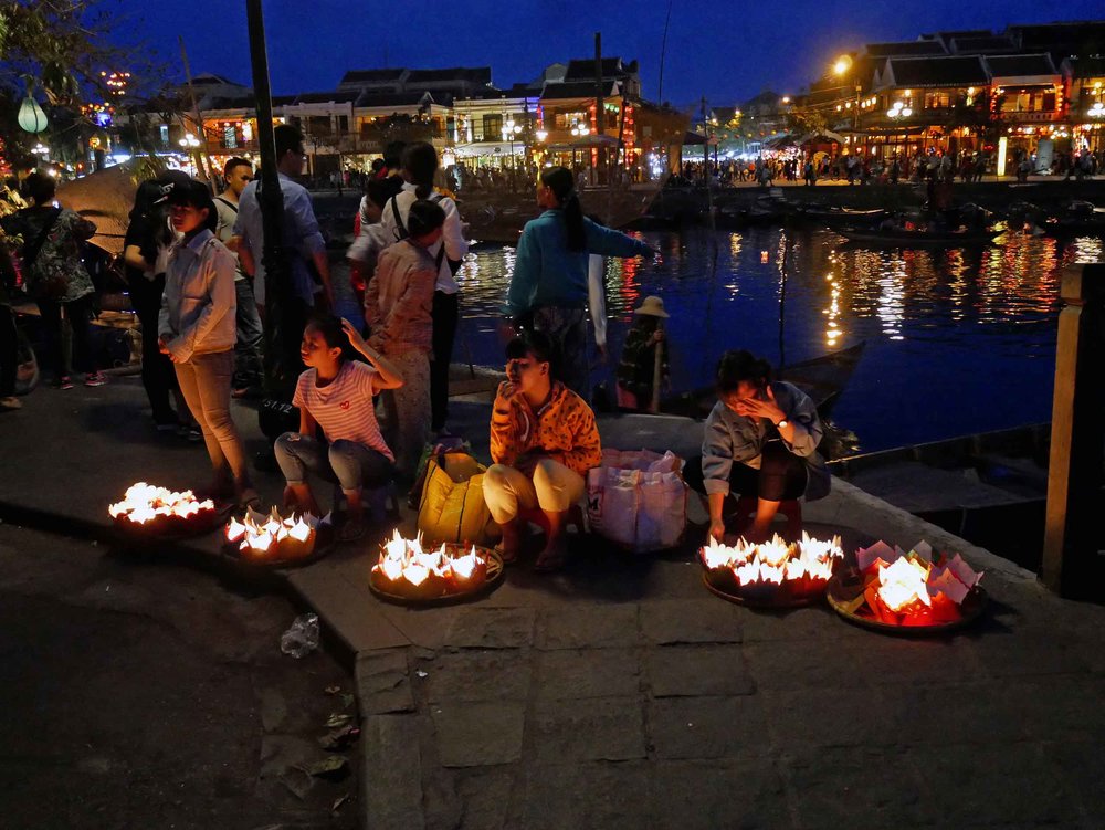  As night fell, women and children sell floating candles that can be set in the river to drift away with your wishes. 