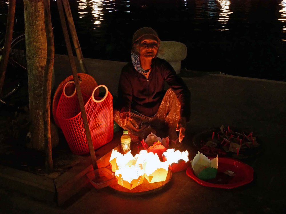 A beautiful candle seller along the banks of the Thu Bon River. 