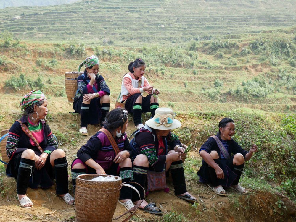  A group of gossiping Hmong tribeswomen briefly pausing from their daily commute with tourists (Mar 24). 