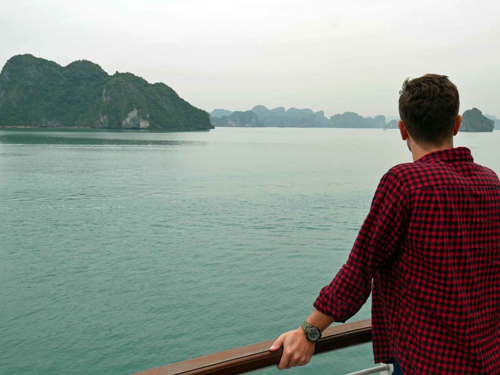  Martin taking in the beauty of these towering limestone islands from the deck of our cruise ship, The Cristina Diamond (Mar 27). 