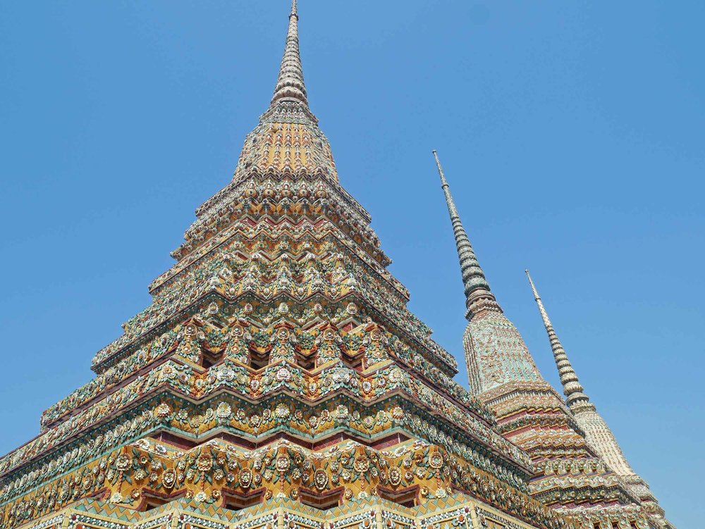  The colorful tops of Phra Maha Chedi Si Rajakarn within the Wat Pho complex and dedicated to the first four kings of Thailand's Chakri dynasty. &nbsp; 