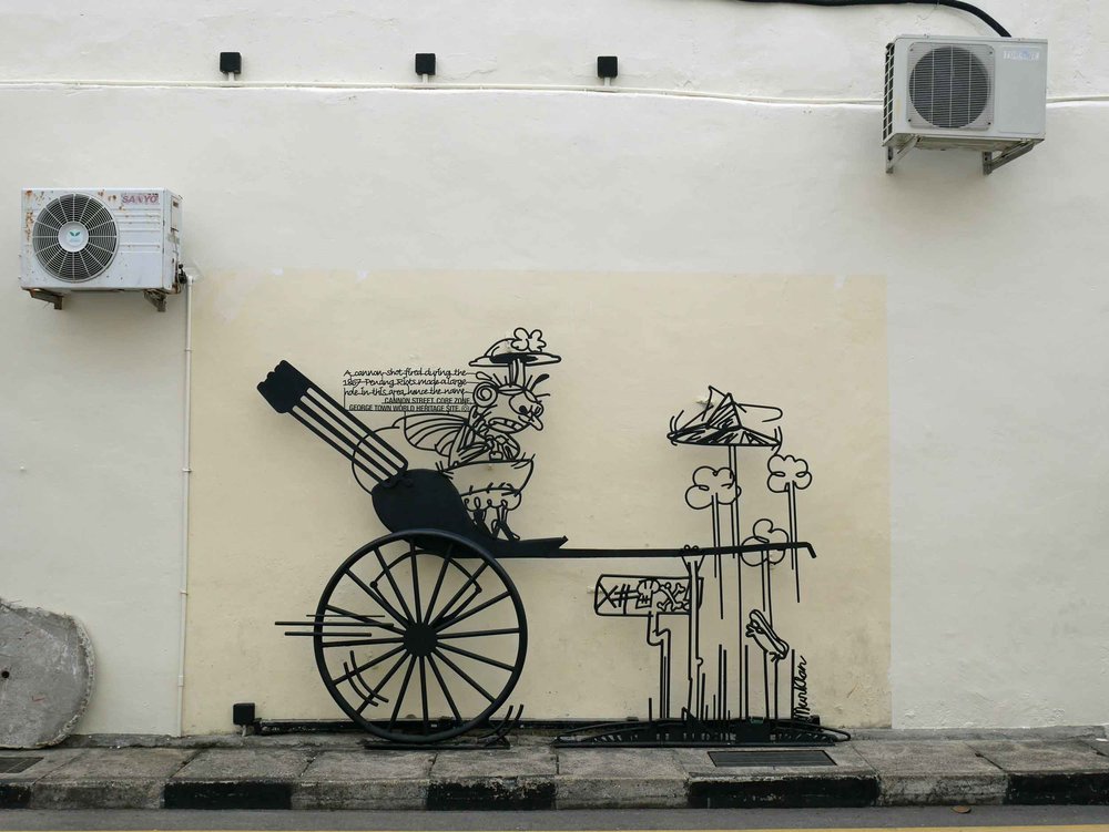  The metal wire artwork, also found on the streets of George Town, is cartoon-like with humorous observations about Penang culture. 