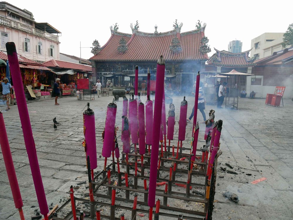  Also located on the "Street of Harmony," giant sticks of incense burned outside Goddess of Mercy Temple, a Taoist temple built in the early 1700s.&nbsp; 
