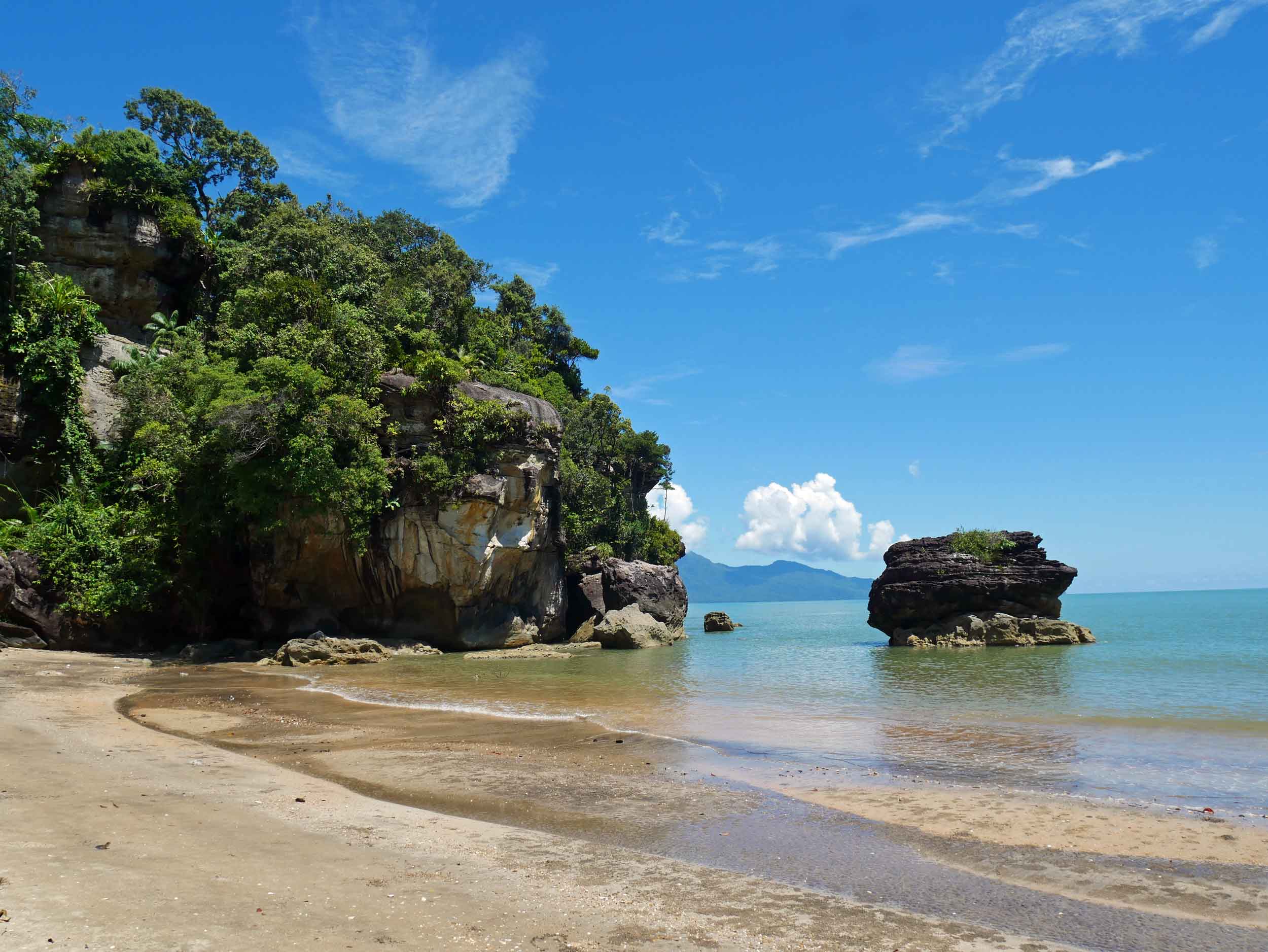  The trail ends at beautiful white sand beach with big rock formations carved by the sea.&nbsp; 