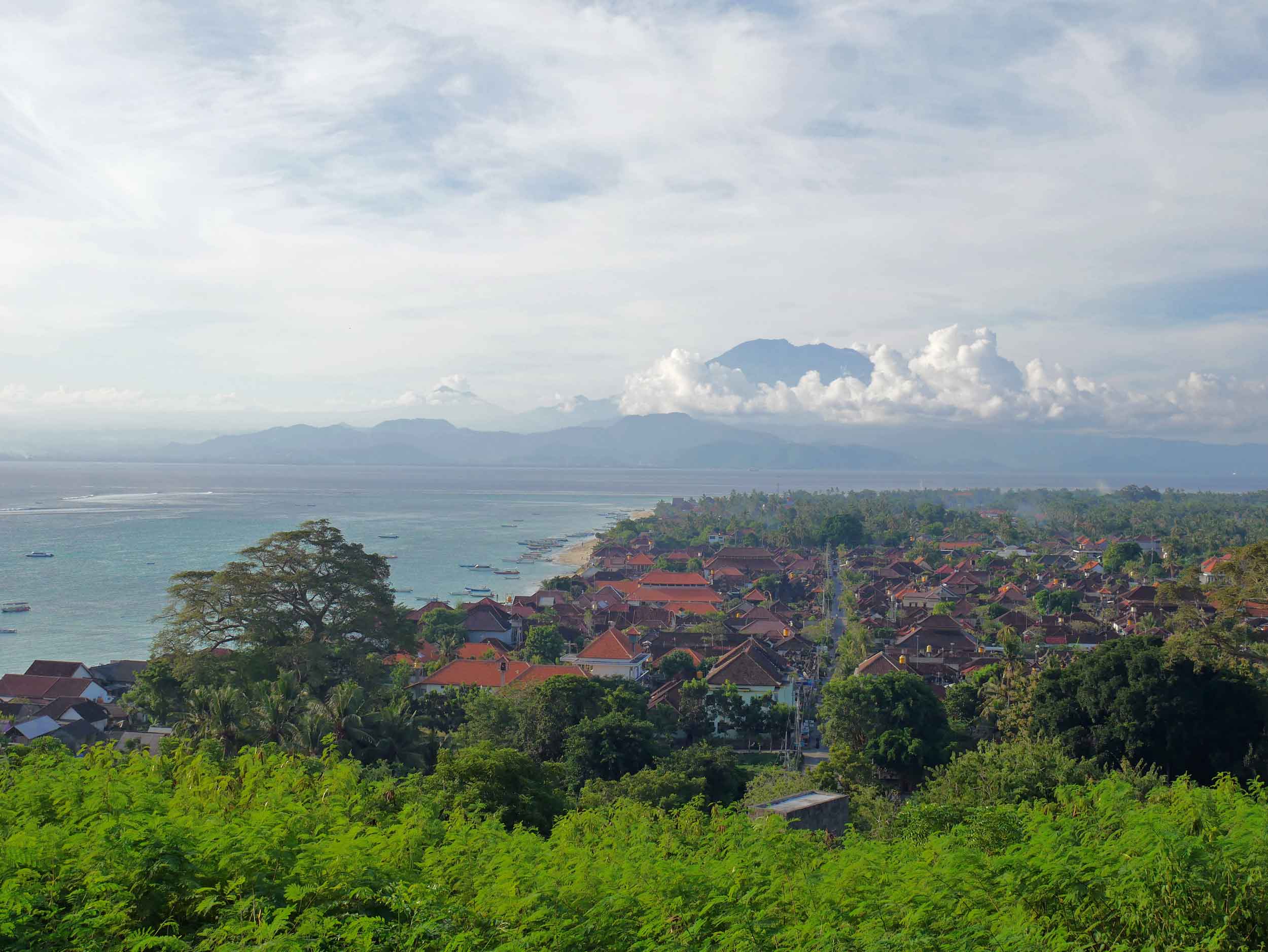  The view of Lembongan’s port town with Bali’s Mount Agung rising above the clouds in the background (May 16). 