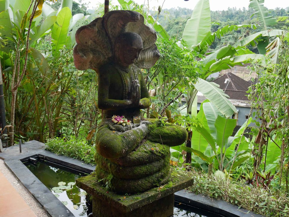  A moss covered statue sat peacefully at the entry to Intutitive Flow.&nbsp; 
