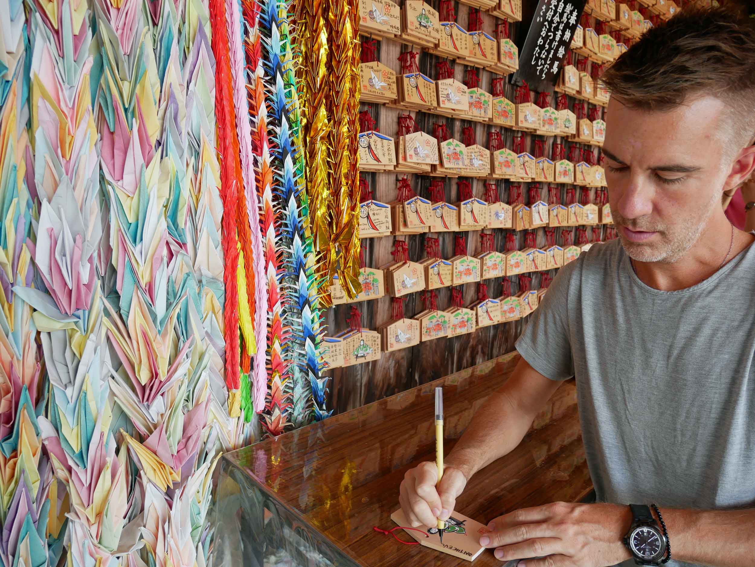  Trey makes a birthday wish to be hung with many others at the shrine's entrance.&nbsp; 