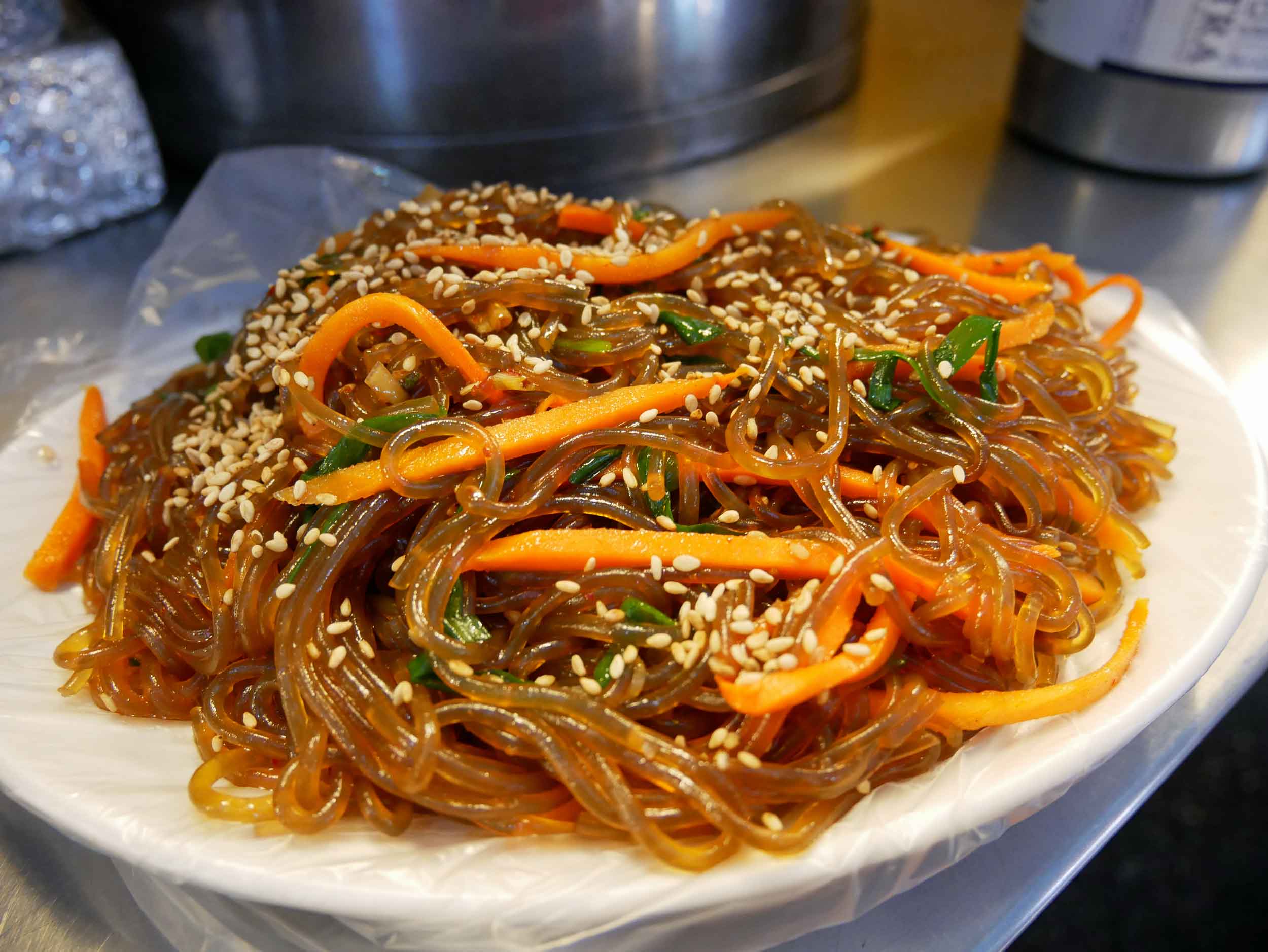  As well as slurping down  japchae , or Korean glass noodle stir fry. 