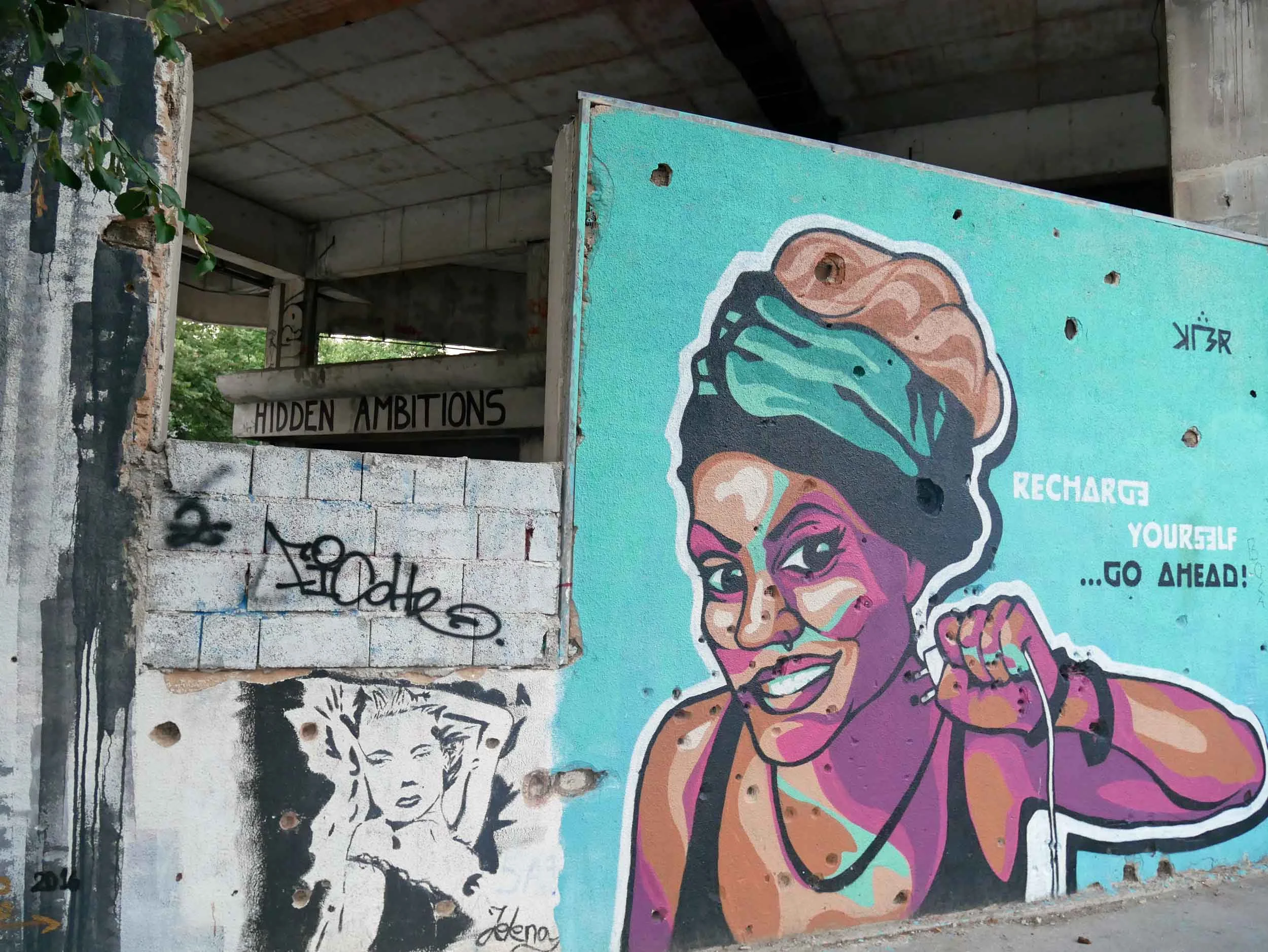 Vibrant murals and artistic expression cover the still empty shelled out high-rise. 