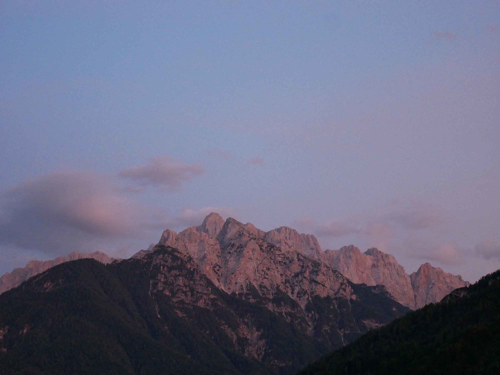  Returning back to Podkoren, where we'd spend the night, the setting summer sun turned the surrounding mountains beautiful shades of pink.&nbsp; 