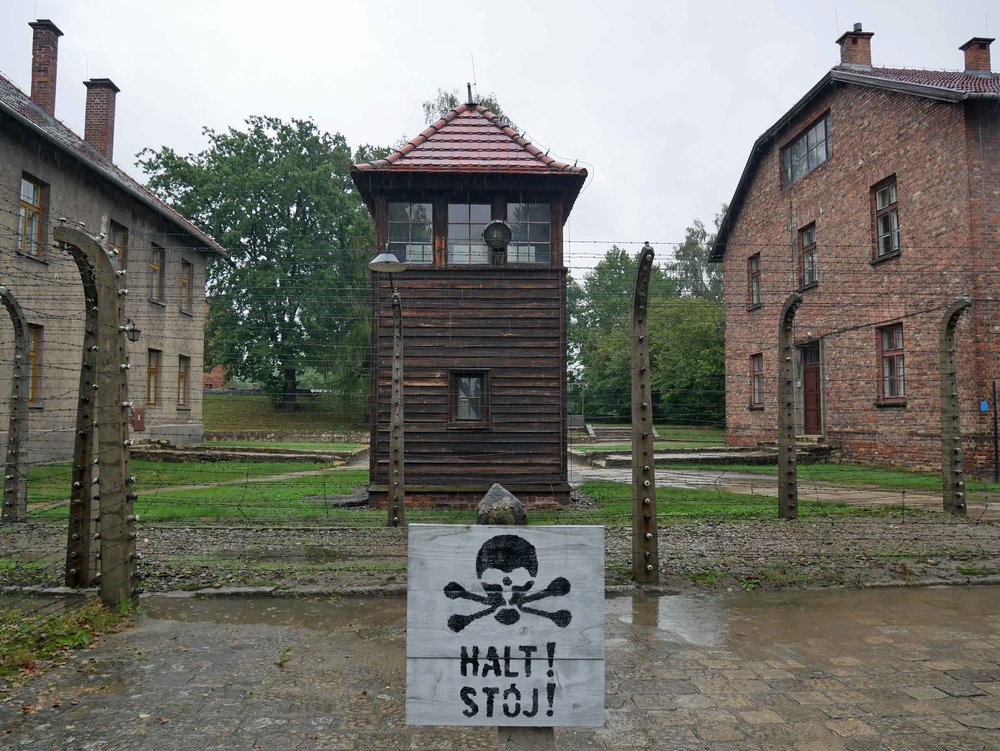 The camp's 16 brick buildings were guarded by towers, barbed wire and warning signs painted with skulls and crossbones, called  totenkopf  in German. 