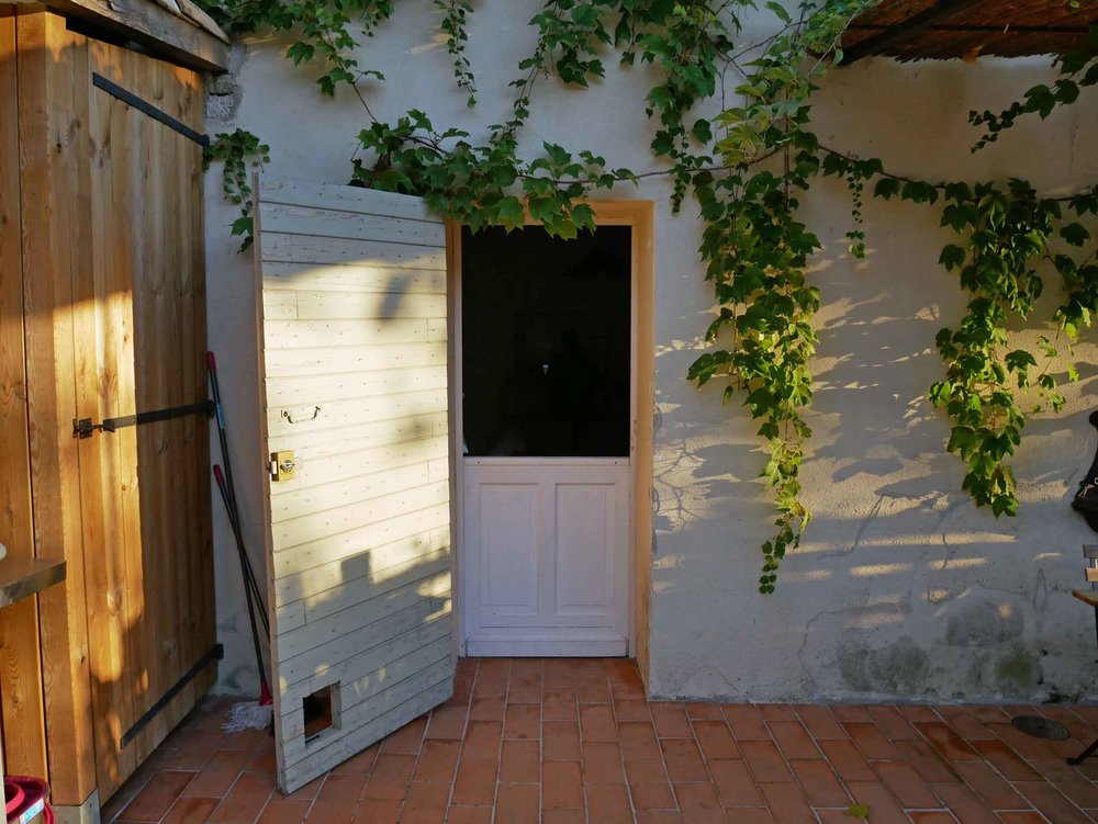  No chateau is complete without an adorable double-hung farm door to allow in the summery French breeze. 