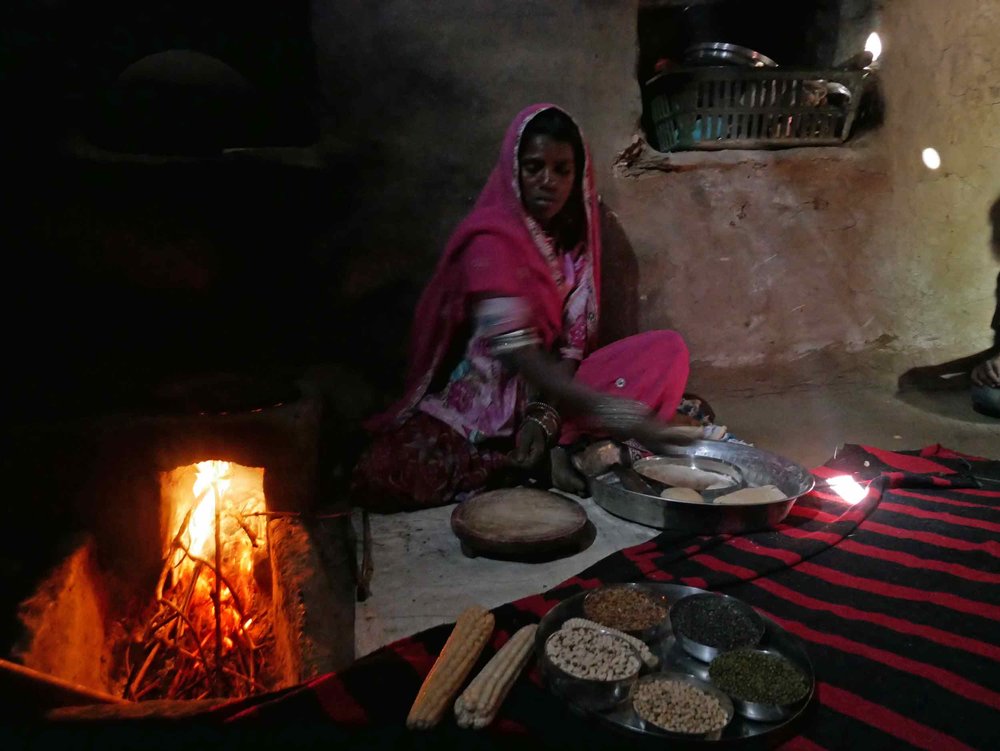  Our gracious host showing us how to prepare and bake  chapati &nbsp;over her home's open fire.&nbsp; 