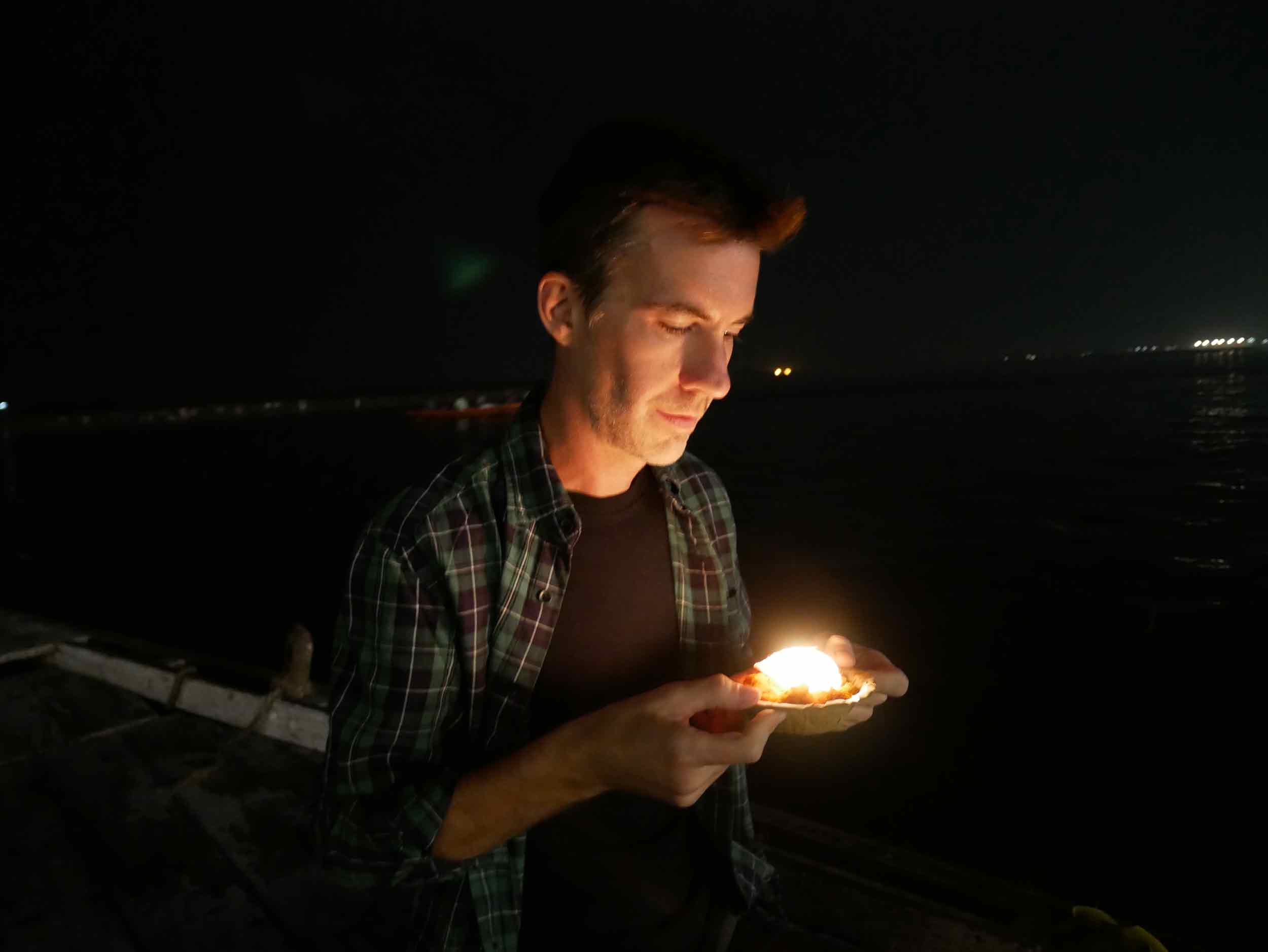  Trey making a  puja , or prayer offering,&nbsp;to the holy Ganga river. 