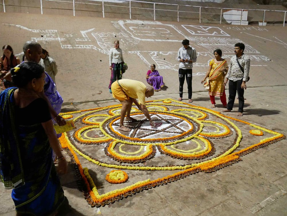  A giant mandala was being created and offered on the  ghats . 