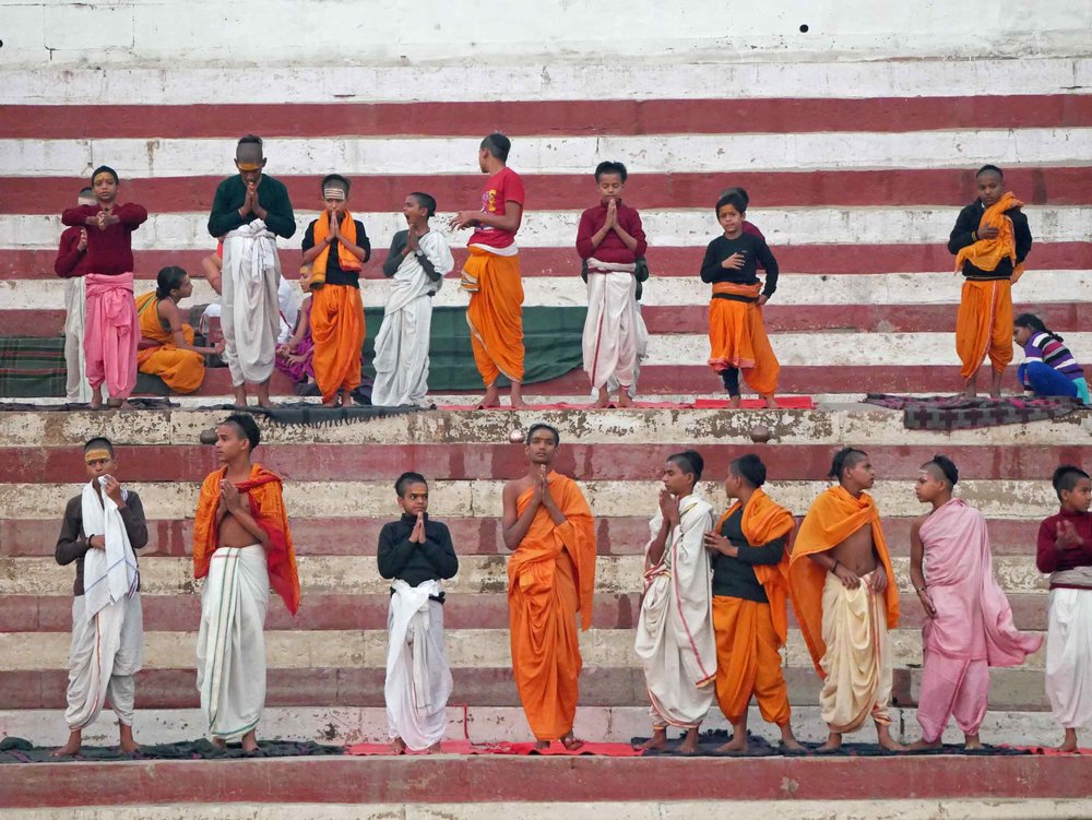  Young Hindu monks praying at the riverbank. 