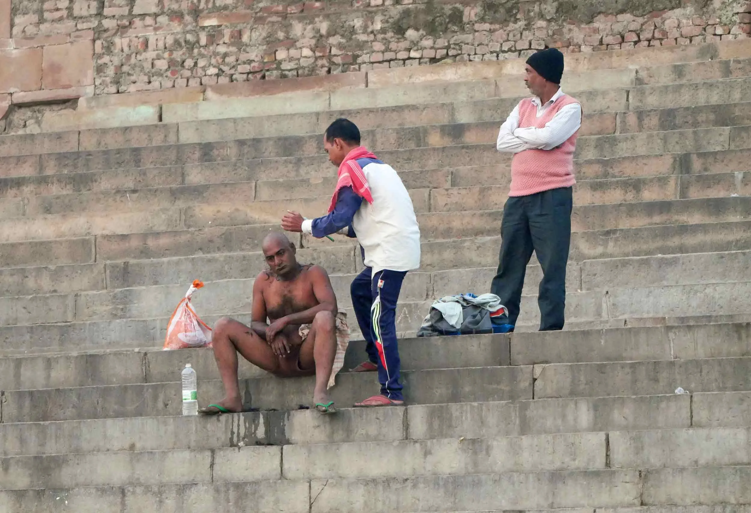As part of Hindu cremation ritual, male family members of the deceased shave all of their hair.