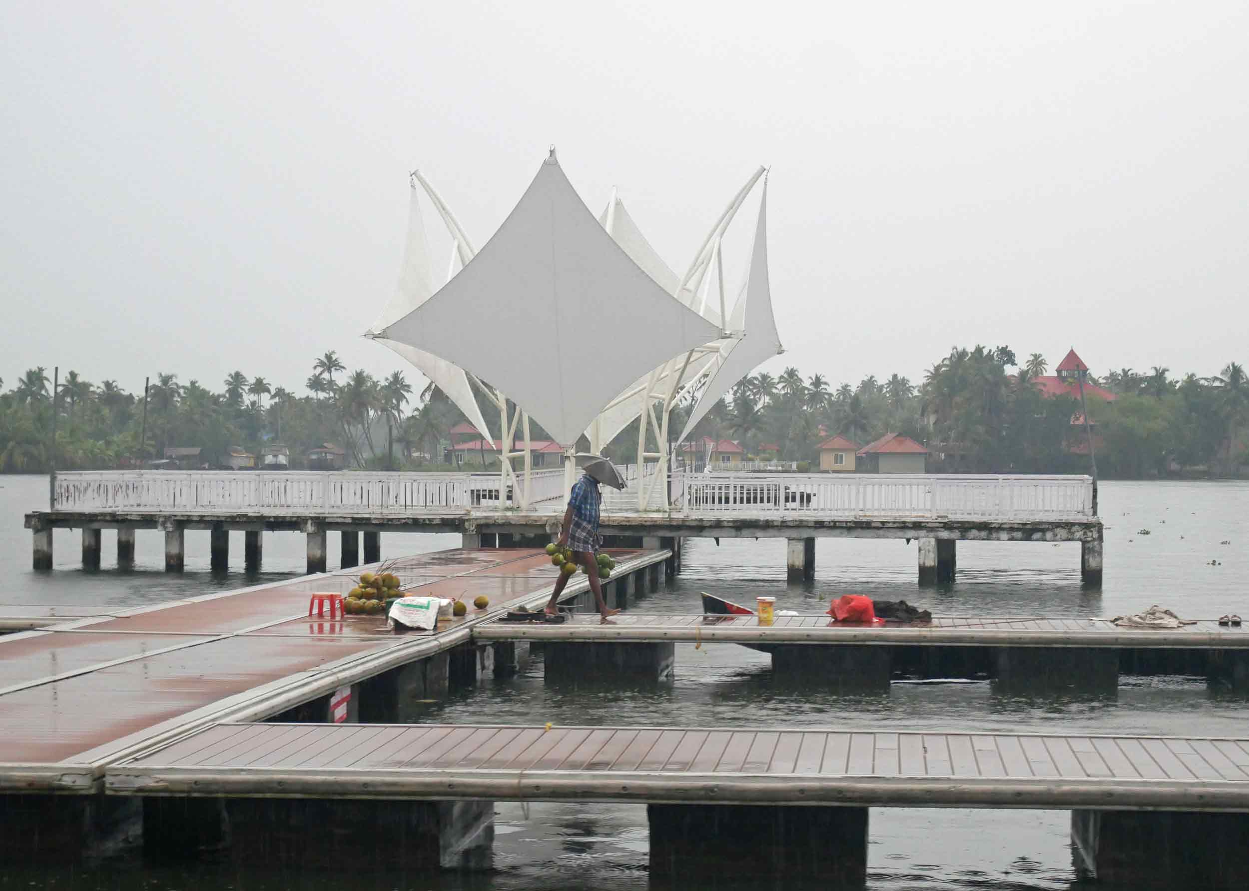  Working even in the pouring rain, this boatman has a clever umbrella hat to protect him. 