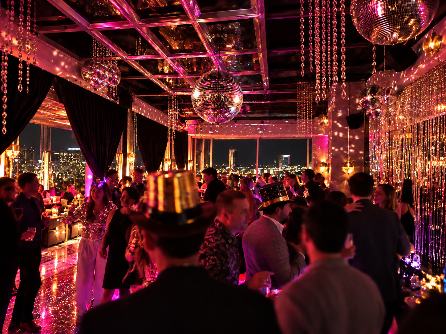 Guests dancing beneath colorful lights and a disco ball at a lively new years eve L.A. Jackson event.