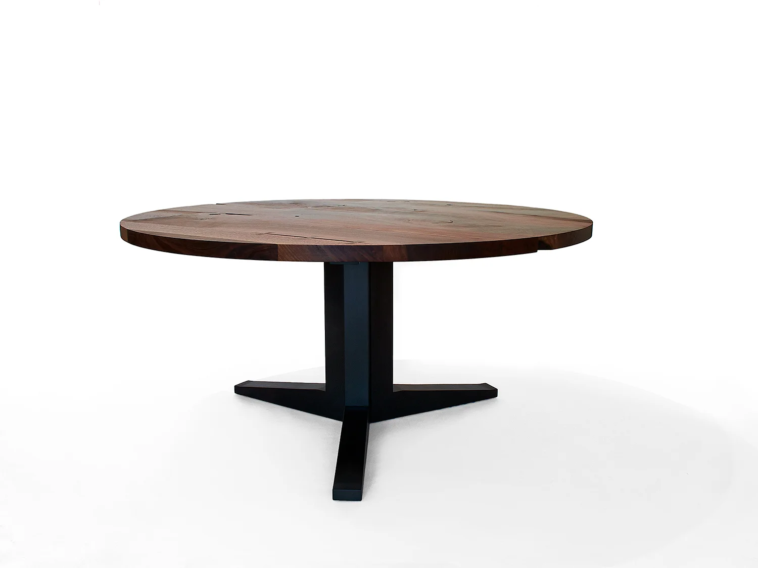 60"Diam. x 29"H Top: Claro Walnut Base: Blackened Maple