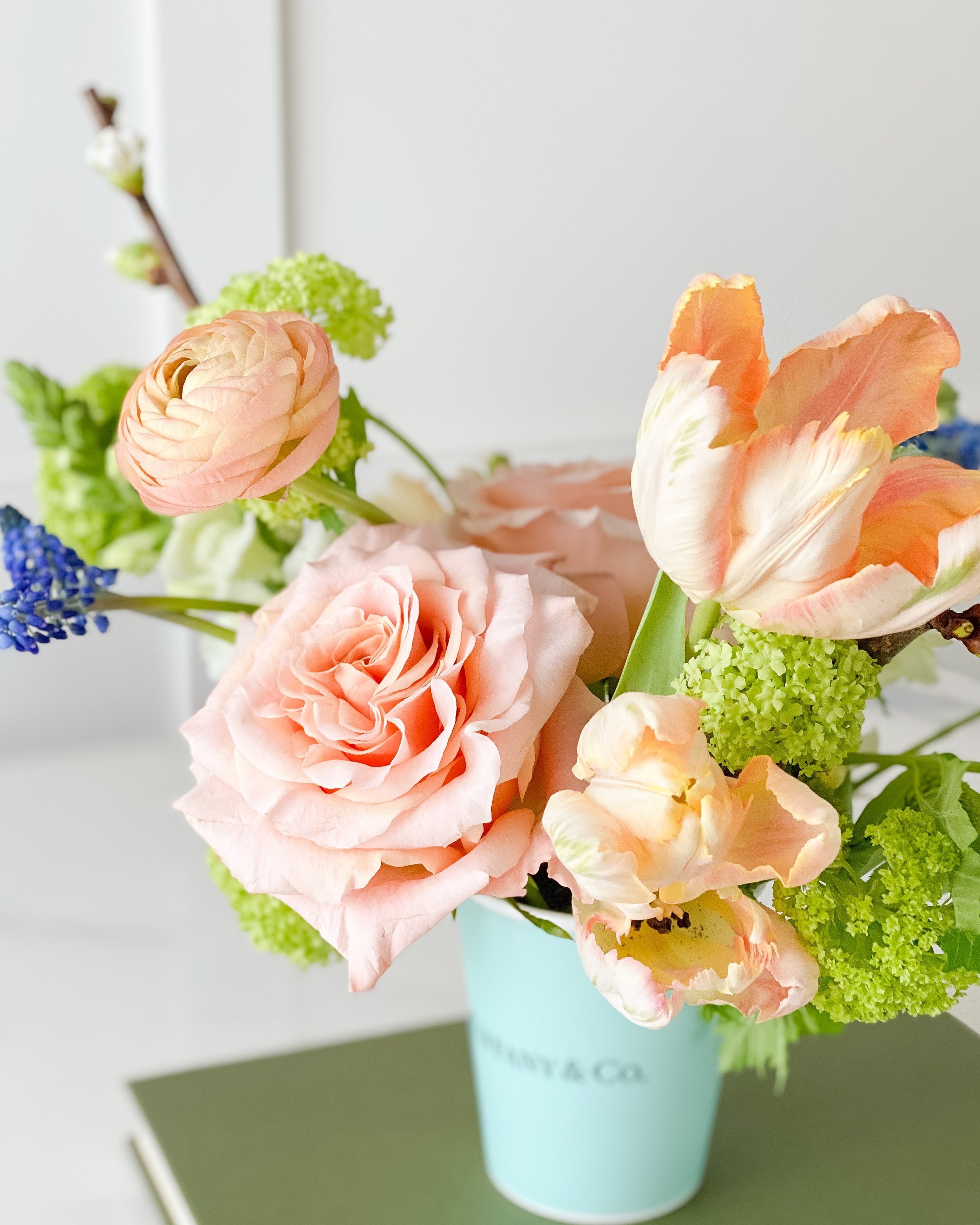 A bouquet of peach and pink flowers in an Easter bouquet. Easter workshop held in Saskatoon at the Twig & Bloom studio.