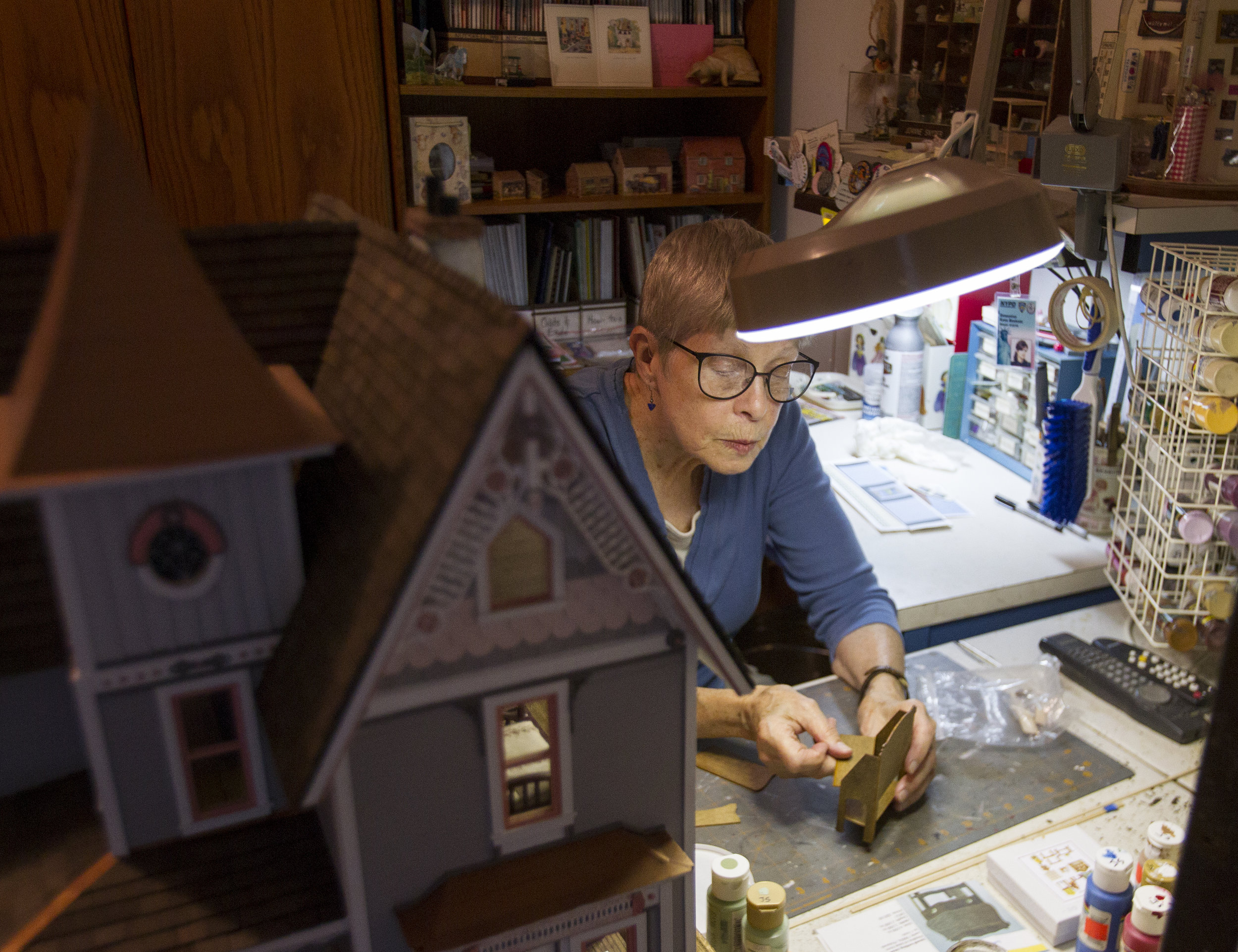  Joanne Snyder works on piecing together some furniture at her crafting desk in her home in Eugene. Snyder has several places in her home where she still works on minis, and a variety of her works on display in her living room including a piece that 