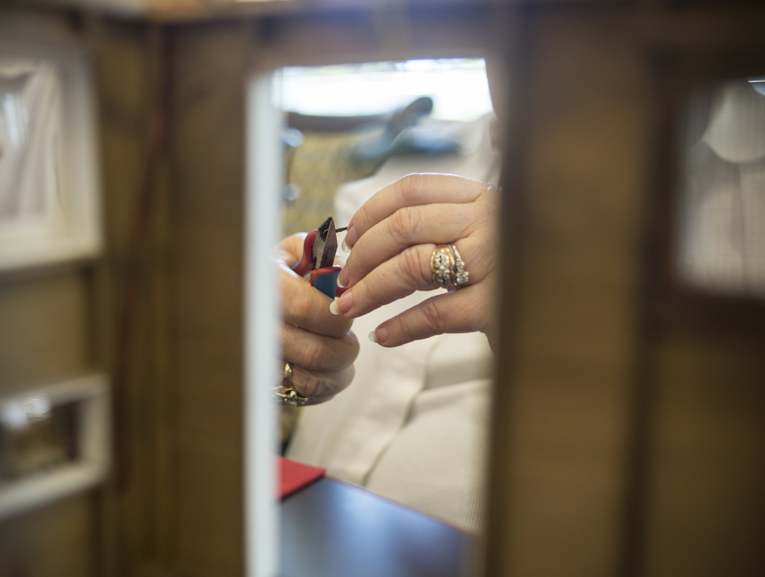  Joyce Metcalf works on reshaping the hinges for her door on her miniature model of a chicken coop. Metcalf and the Eugene Minis Club use a variety of materials and repurpose them to make their miniatures models that much more realistic. (Rhianna Gel