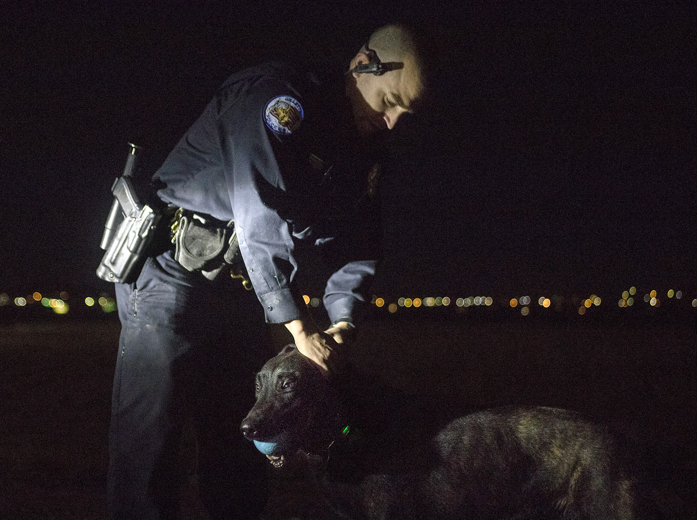  K-9 Officer Brian Roesner pets Chase after throwing the ball for a K-9 exercise at the Field of Dreams on Thursday, April 18, 2019. News Record Photo/ Rhianna Gelhart 