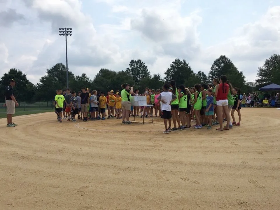Niki Erb leads the kids in a huddle for an emotional  "We love you, Ruby!" shoutout