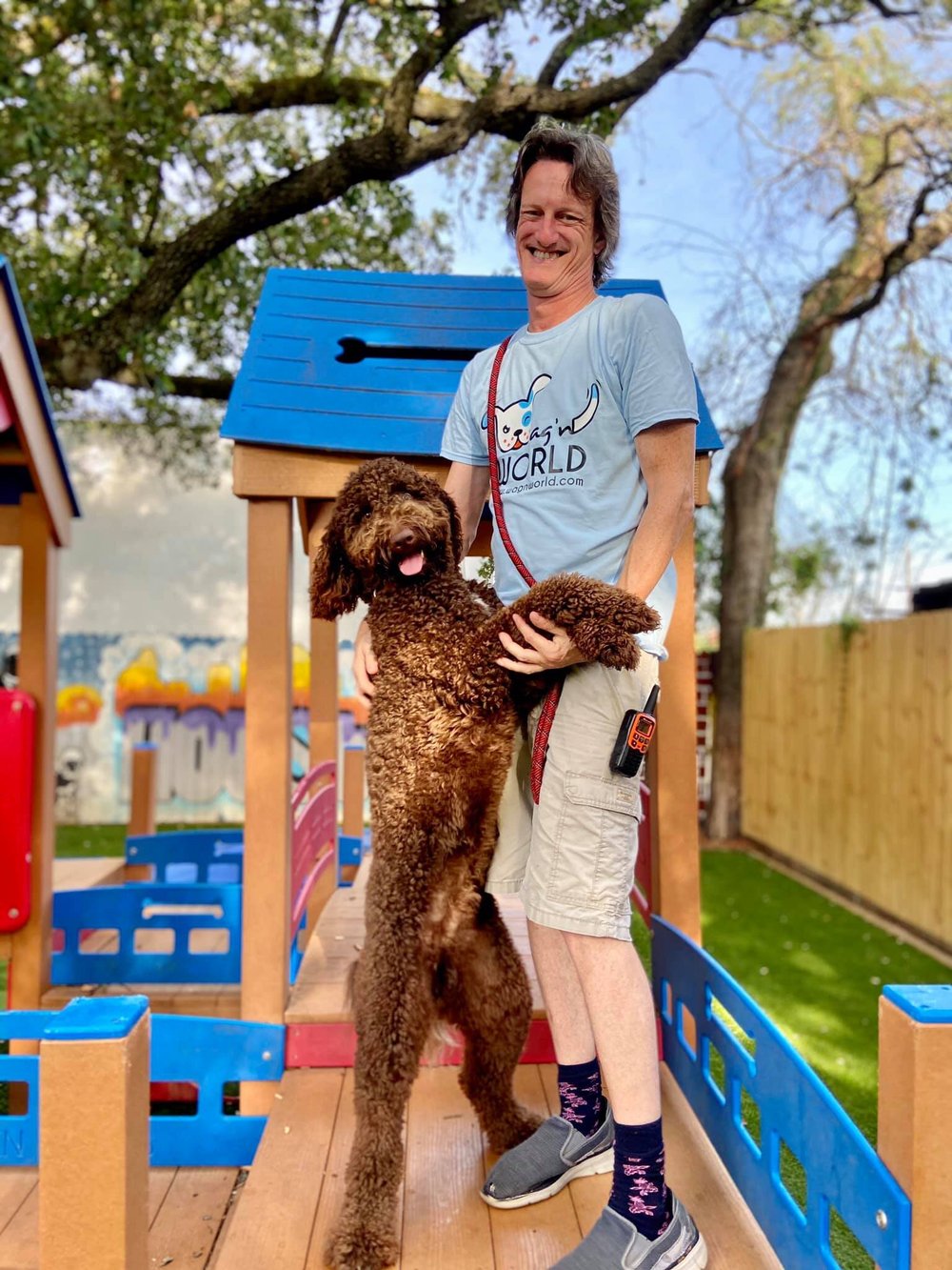 Wag'n World team member in an outdoor play yard