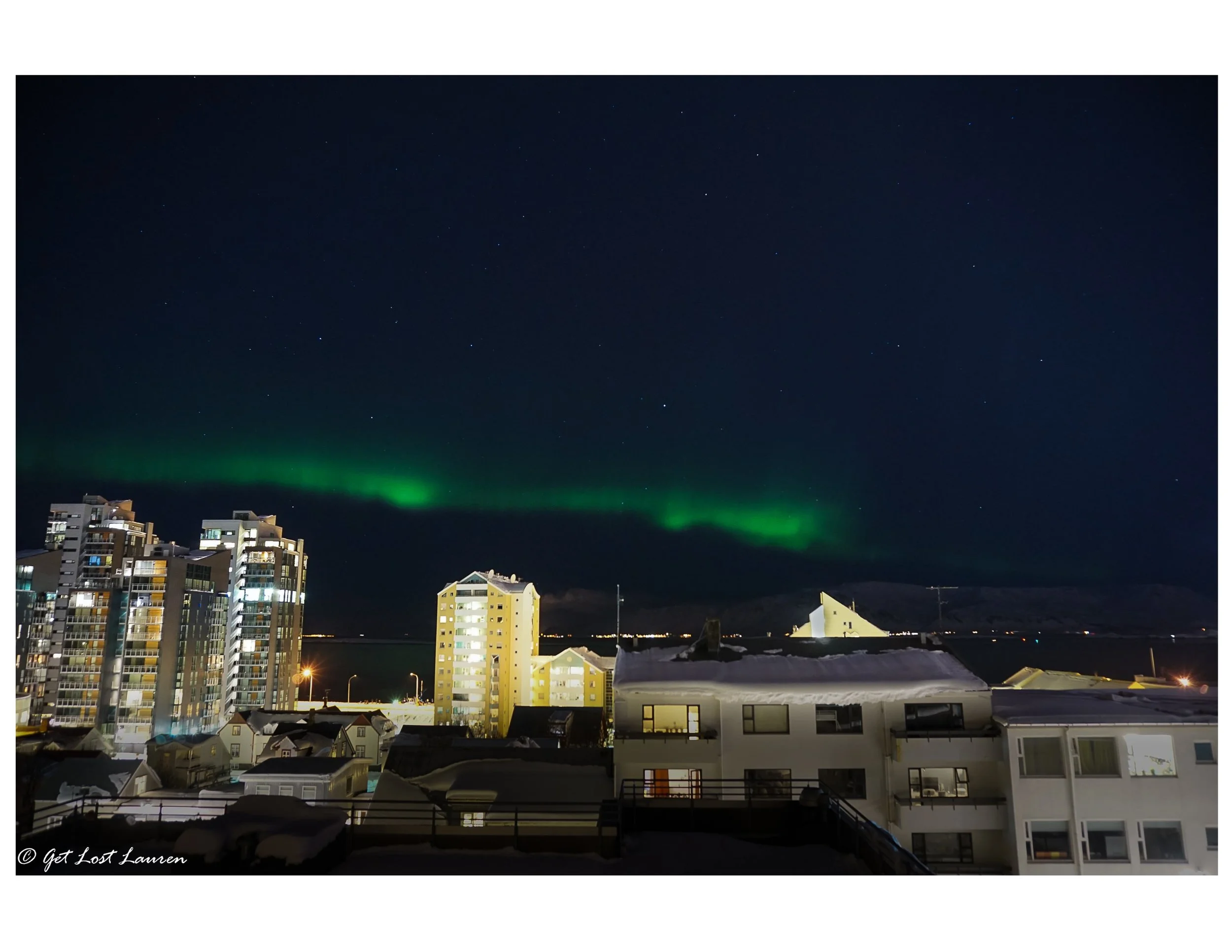 You might not have to go too far to see the Northern Lights. This was right off our apartment's balcony in Reykjavik! Sony a5000. f4/ISO 800/4"