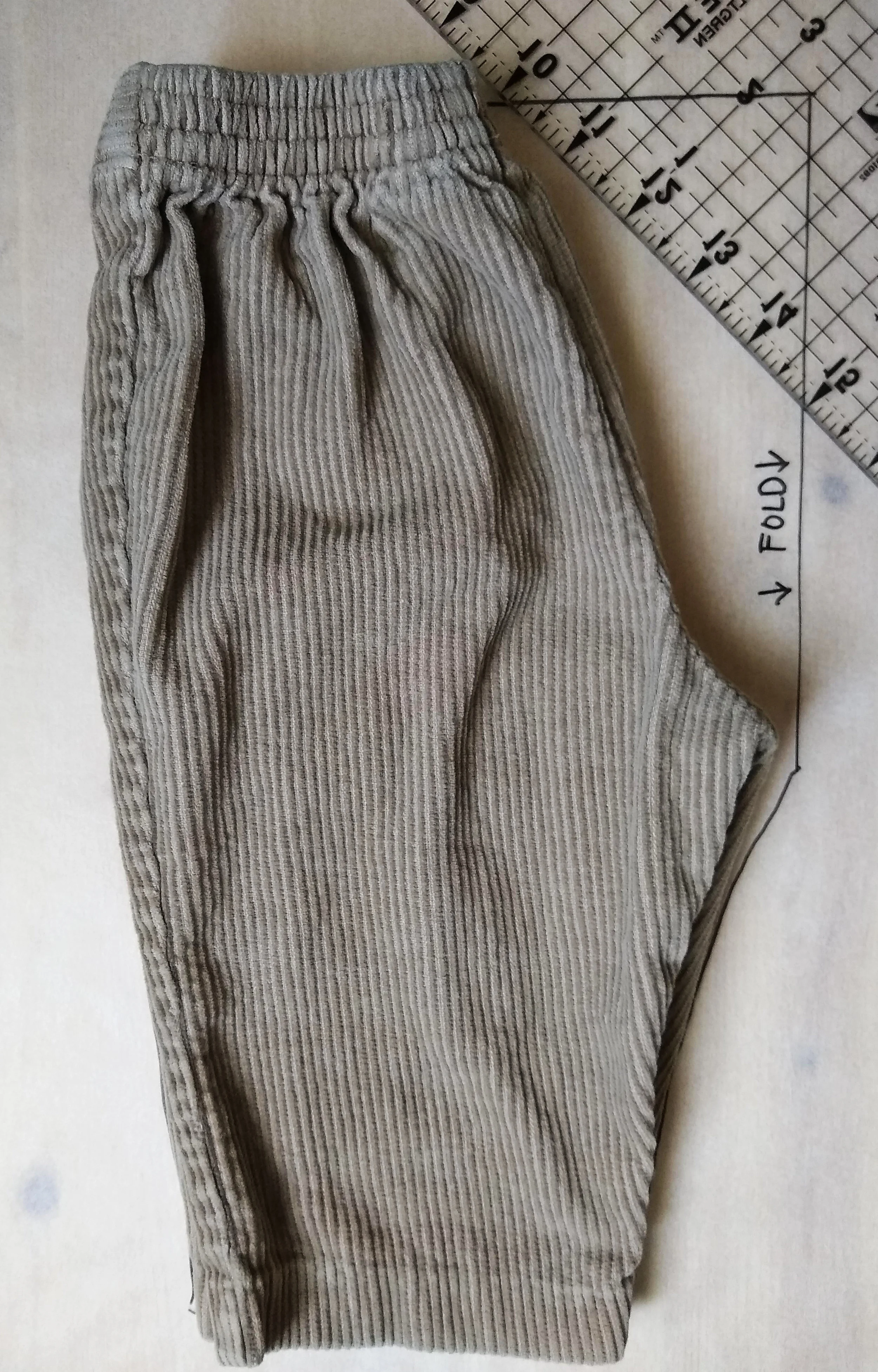 I traced a pair of slightly large pants, folded in half, extending the outline straight from the crotch up to a straight line drawn across from the waistband.