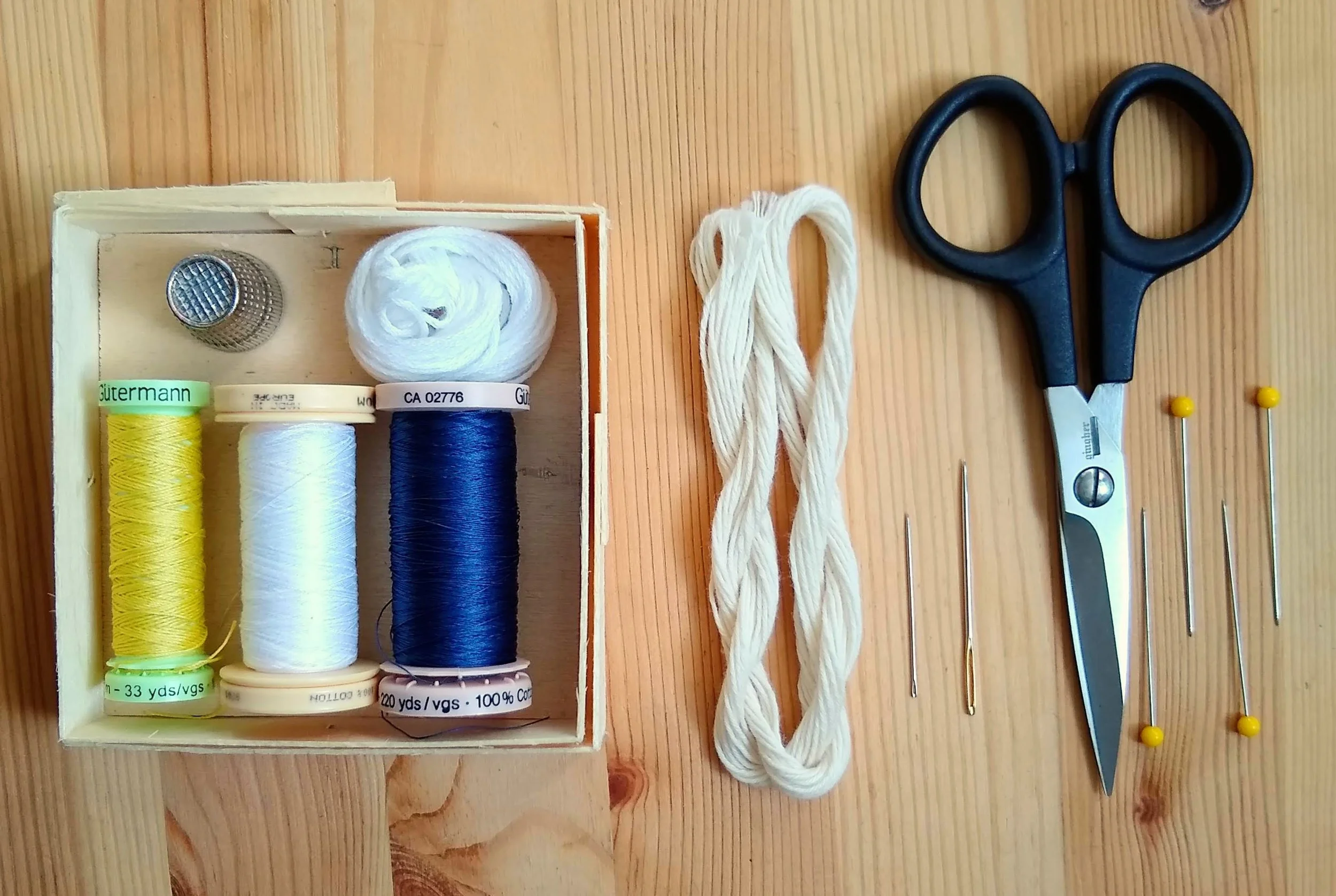Mending haberdashery: Sewing thread (in colors to match patches and denim, standard thimble, embroidery floss or Japanese sashiko thread, a heavy duty sashiko or embroidery needle, a standard hand sewing needle, and sharp, pointy scissors.