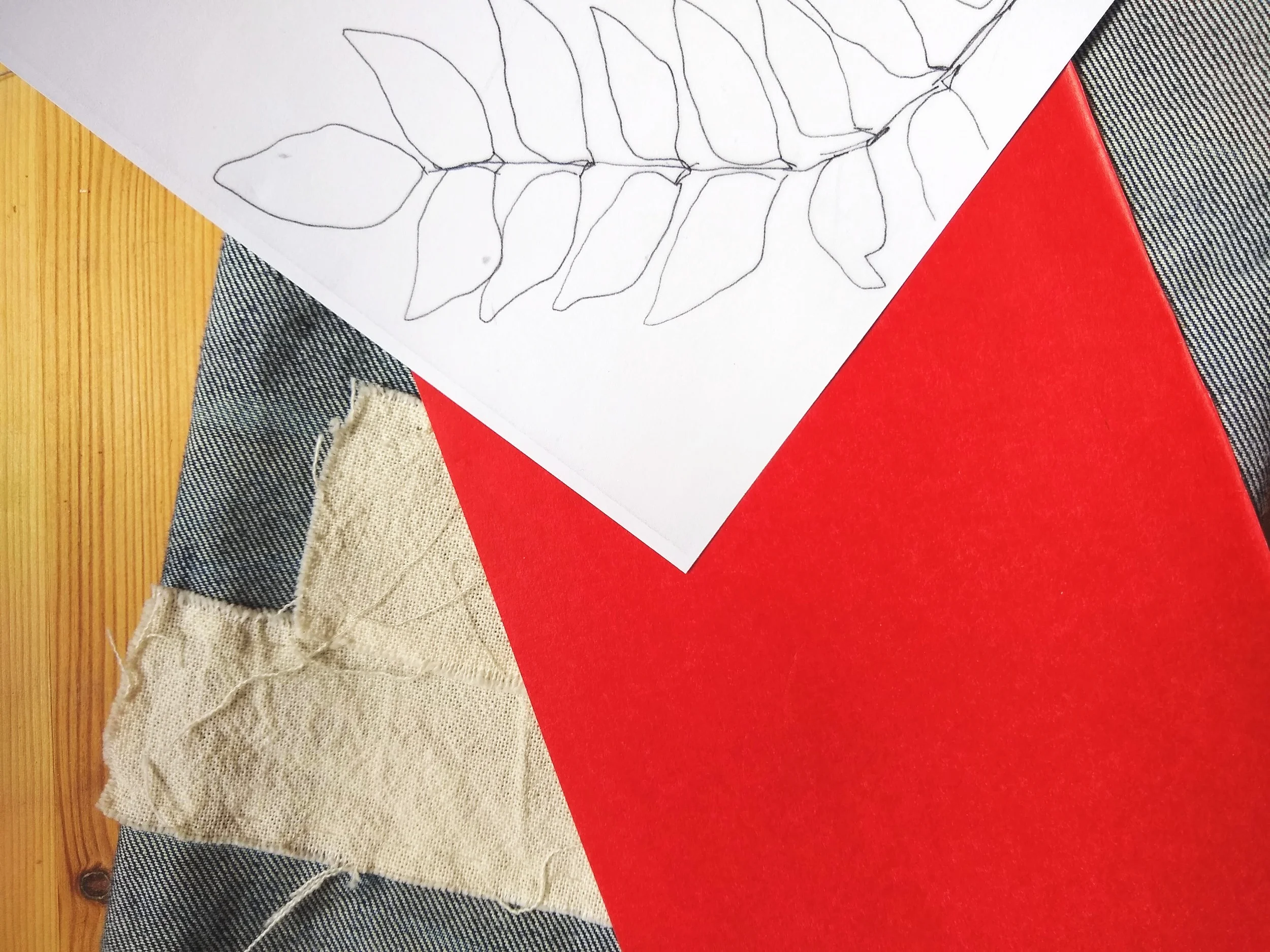 I made several copies of my original floral template because I knew I would use it at least four times in the project. The red paper is the transfer paper. You can see that the Japanese stitching cloth used to patch the holes is quite flexible and won’t add stiffness to this area of his pants.