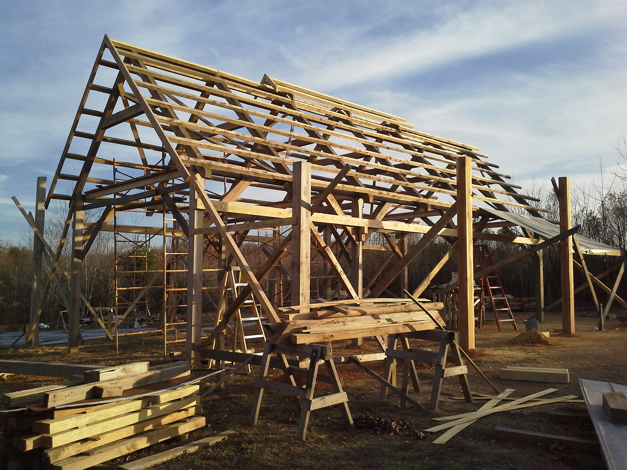 This is timberframe type construction for the kiln shed. I chose the timberframing method because I've always loved log-type construction. It's a very strong and durable method of construction. The shed is tall because I've had experience firing many wood kilns and almost all of the sheds are too short. During a firing, you may find yourself in a cloud of reduction smoke and it gets hot. I didn't want that for my shed. Aesthetically, it's natural. It's what I want to be around when I'm making and firing pots. 