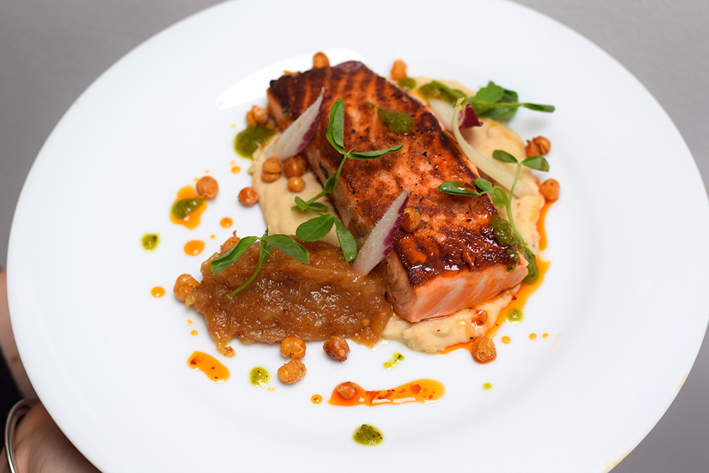 Pan roasted salmon, crispy paprika pork skin, white bean puree, dukkha spiced apple sauce, crispy chickpeas, red and green chilli and pea shoots