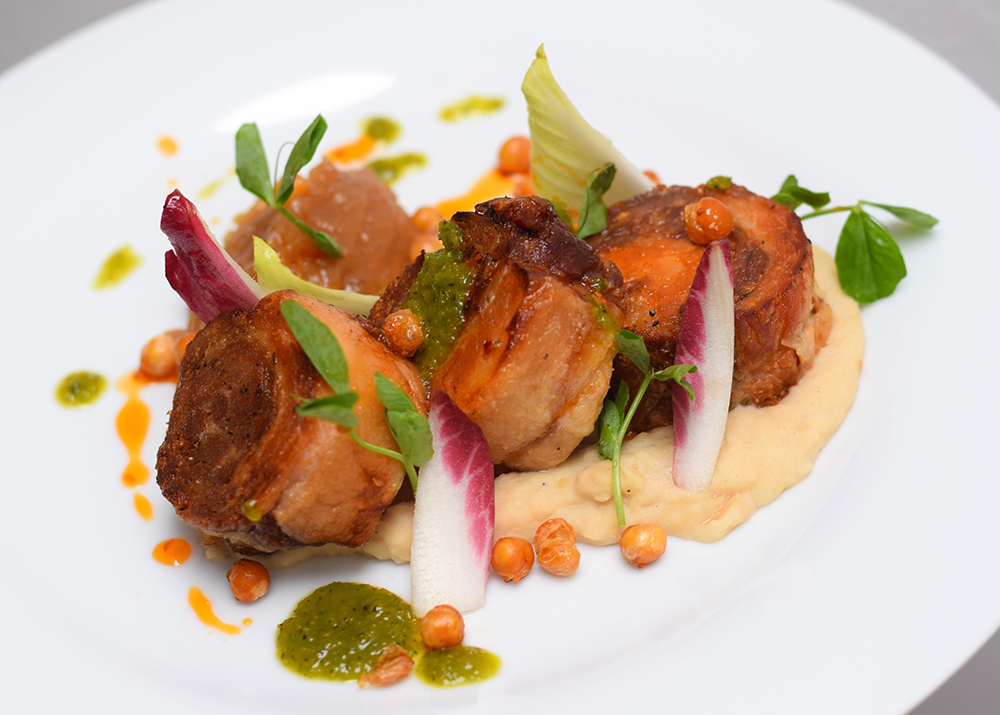 Rolled pork belly, crispy paprika pork skin, white bean puree, dukkha spiced apple sauce, crispy chickpeas, red and green chilli and pea shoots