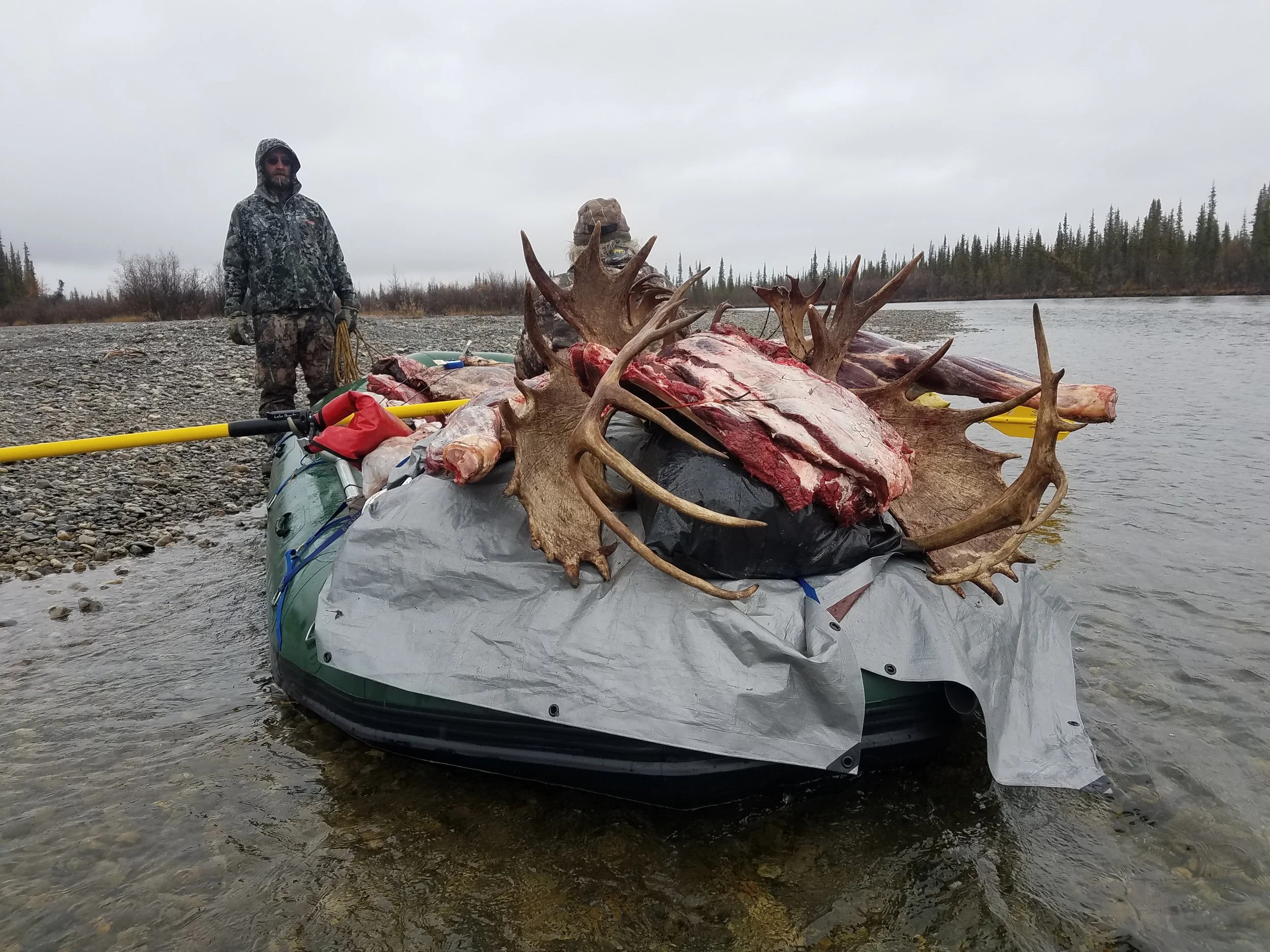 Packer Robert Hoth stands next to a fully loaded raft in the Arctic - Fall 2017