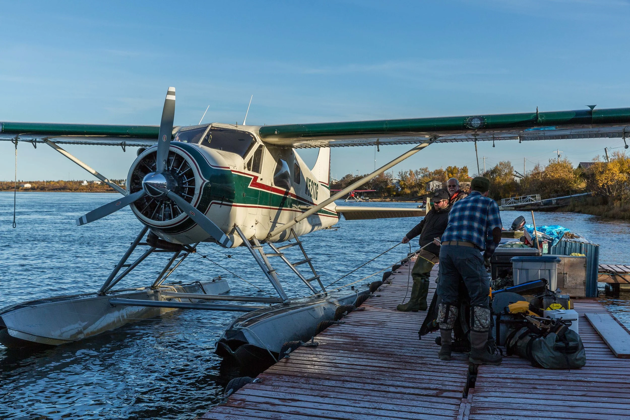 Owner and outfitter Lyle Becker and hunter Doug Tate help load the airplane as they head for camp - Fall 2017