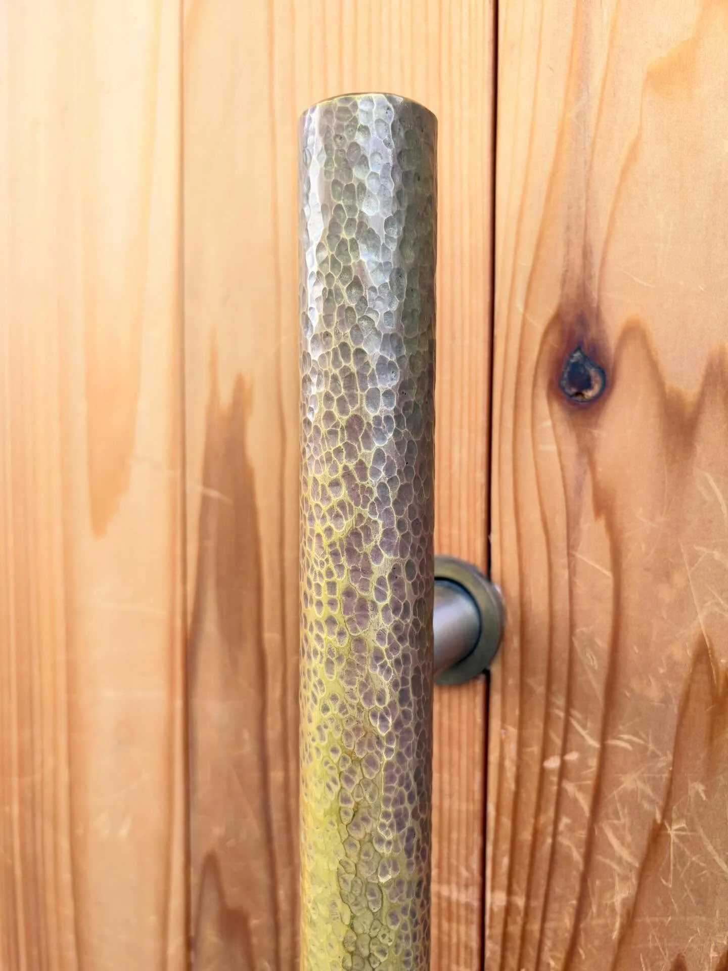 Hand-hammered solid brass door pull for @waltzbar after 18 months of use