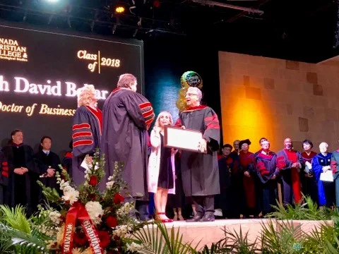 Yosi accepting his degree. 