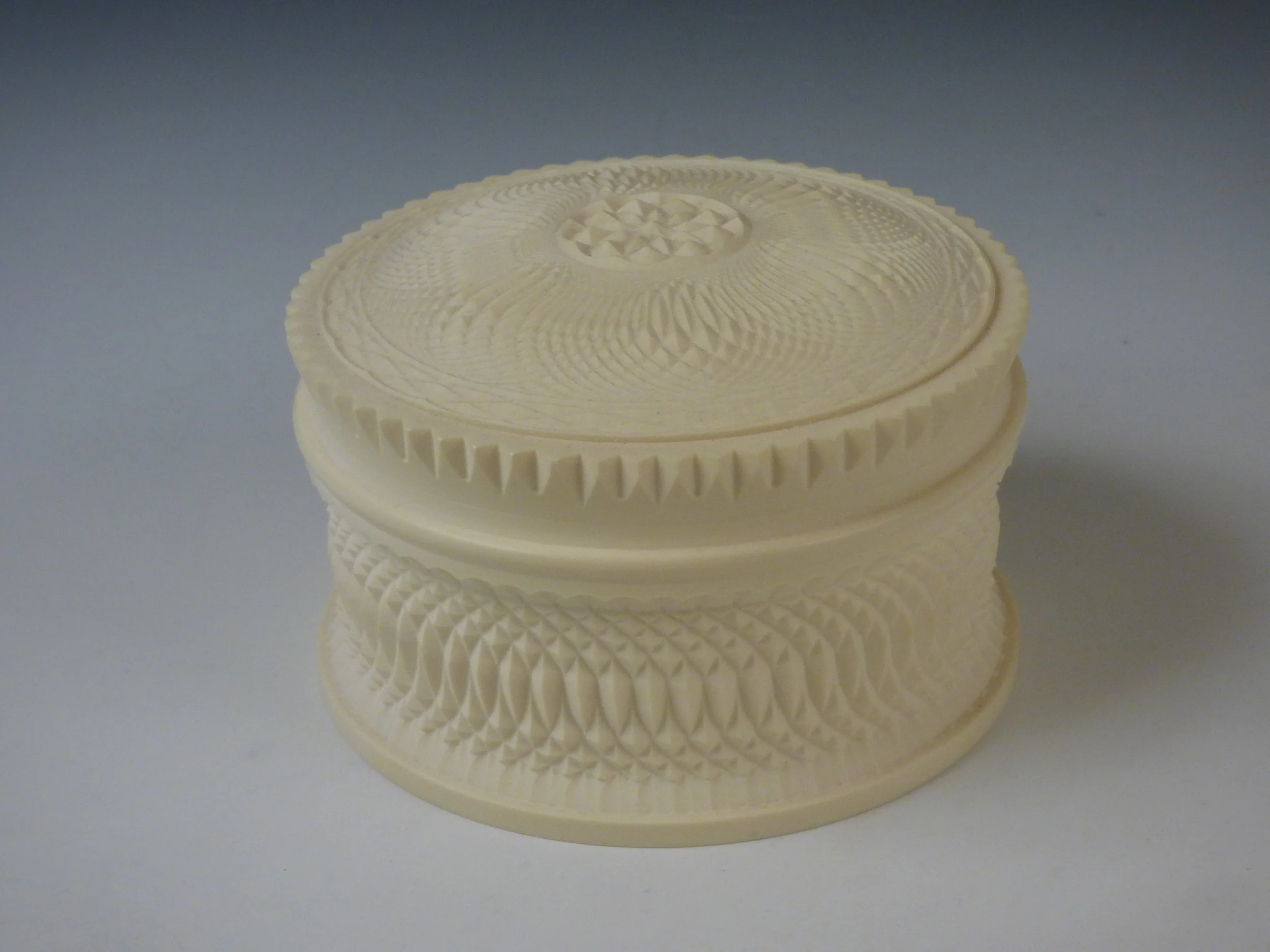 Dewey Garrett. Grace box, 2007. Cast urethane resin. 2 1/2 x 4 in. dia. Courtesy of the Artist. 2016.DG.01. Photo: Courtesy of the Artist METHOD: Hand turned box with fitted lid, carved on home-built ornamental turning machine based on historical rose engine designs