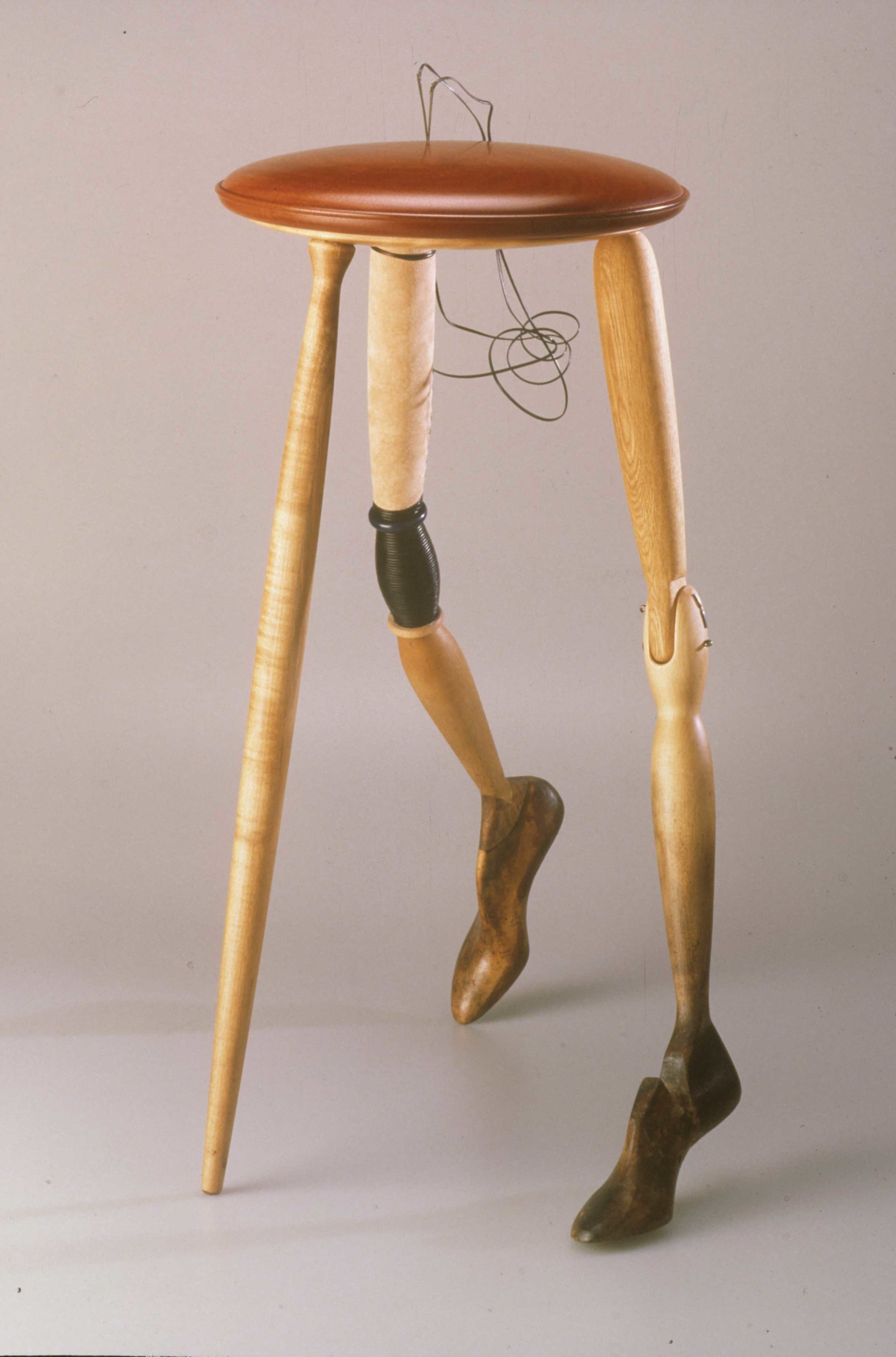 Fig. 7. Neil Donovan, United States. Walking Stool , 1990. Mahogany, oak, maple, suede, leather lace, antique shoemaker lasts. 28 x 12 in. dia. The Center for Art in Wood’s Museum Collection. OBJ 80. Photo: John Carlano 