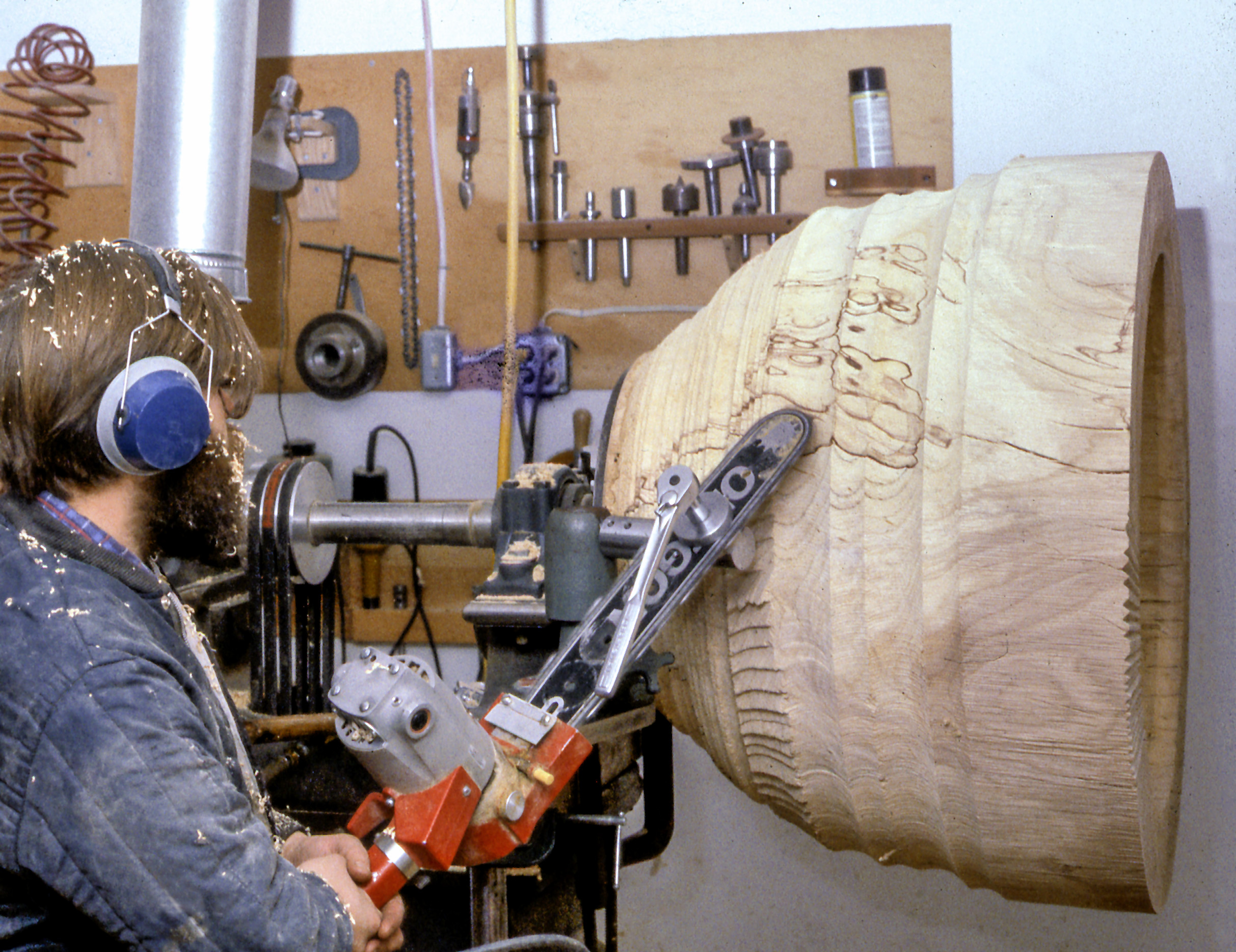 Fig. 21. Mark Lindquist turning his MacDowell Bowl on his lathe with chainsaw adaptation, 1979. Collection of Dr. and Mrs. Alan Lubarr. Photo: Lindquist Studios