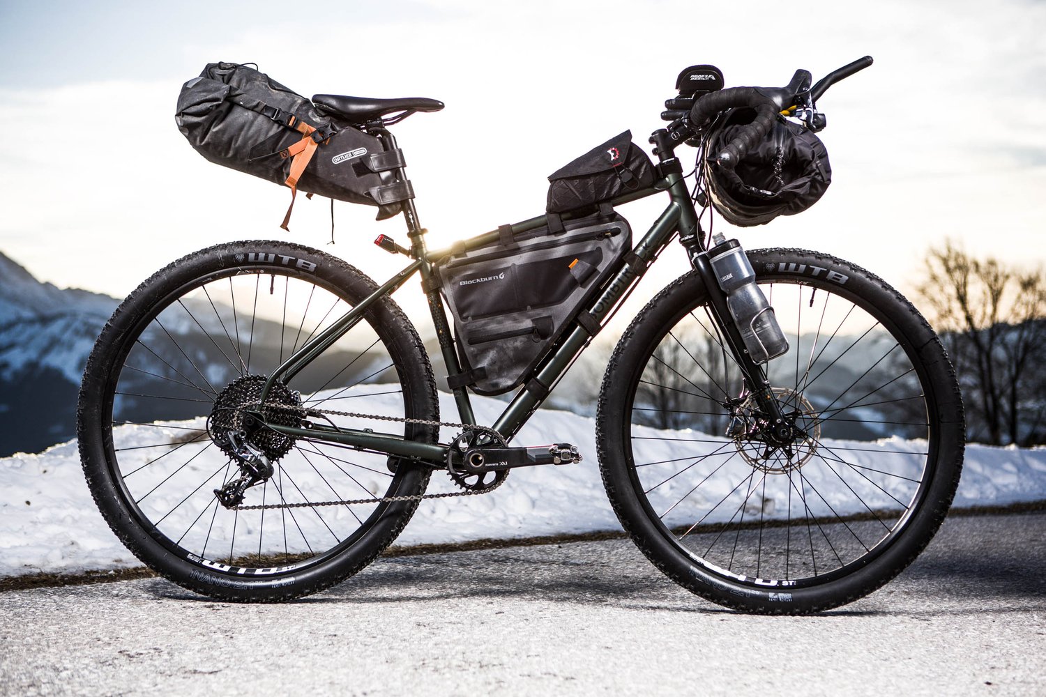 Bikepacking bike with handlebars and seat pack dry bag