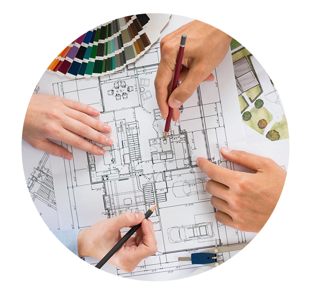 A team of designers reviewing and marking up an architectural plan drawing