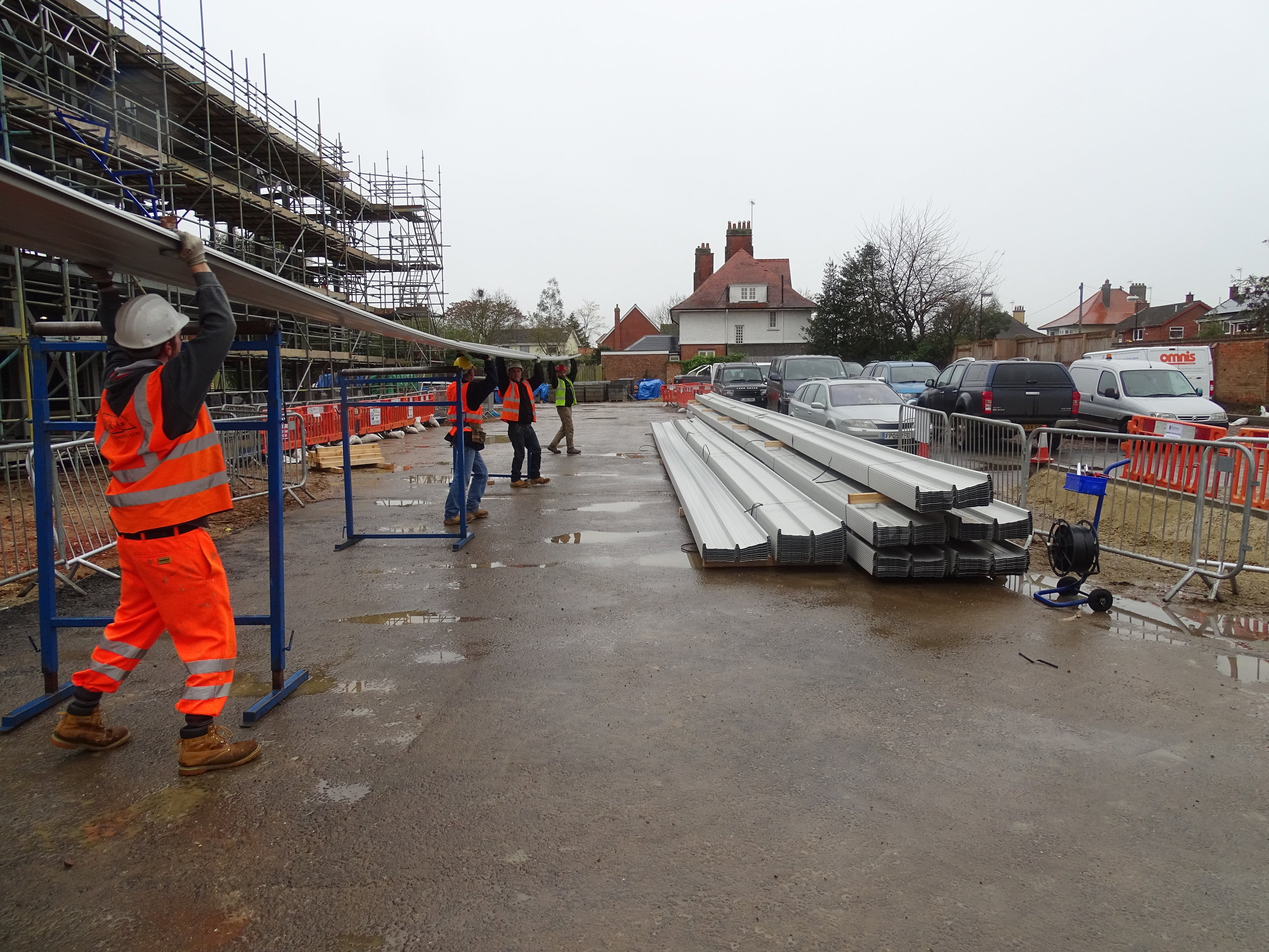 Onsite rolling of Omnis Exteriors SpeedDeck profile secret-fix standing seam roof sheets