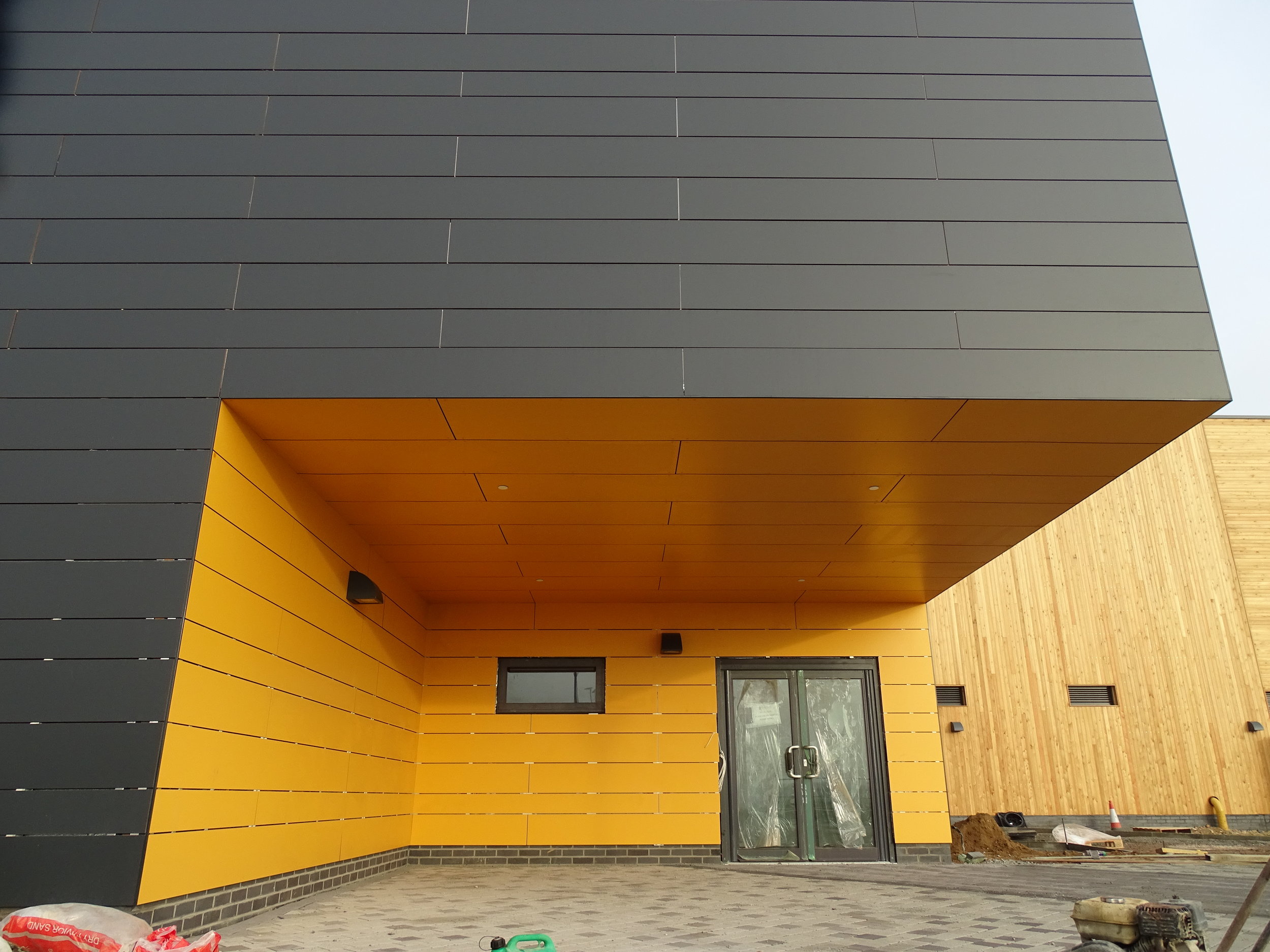 Rockpanel Rockclad rainscreen panels on an aluminium framing system to walls and soffit of sports hall